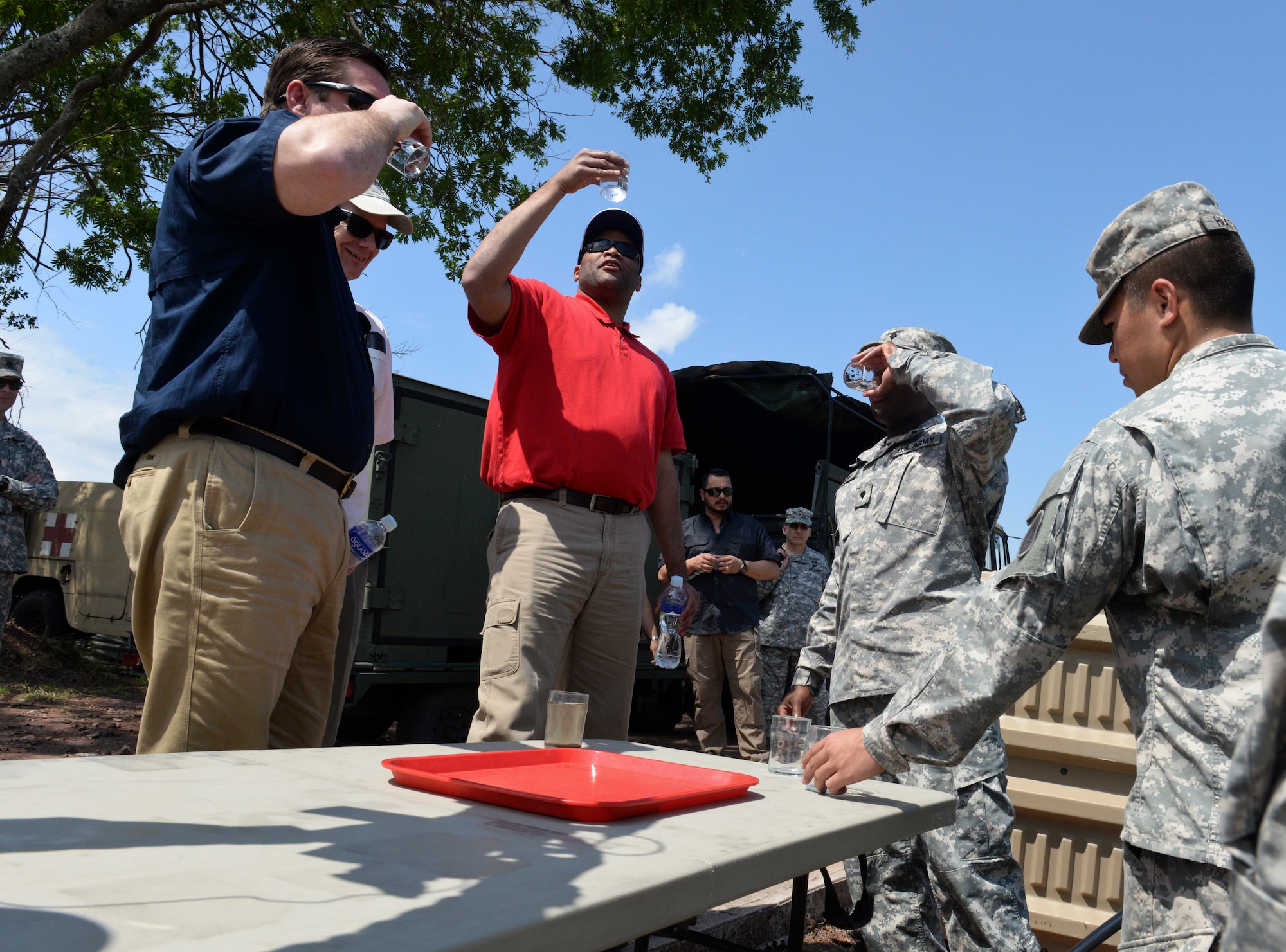 SOTO CANO AIR BASE, Honduras – Congressman Austin Scott (front left), representing Georgia’s 8th District, U.S. Ambassador to Honduras James Nealon (back left), and Congressman Marc Veasey (center), representing Texas’ 33rd District, examine the results of a water purification system during a congressional delegation visit May 4, 2015, at Soto Cano Air Base, Honduras. Technology like that employed in this system enables Joint Task Force-Bravo to conduct transportation, sustainment and medical operations in austere environments, in support of the broader U.S. and partner nation stabilization efforts in Central America. (U.S. Air Force photo by Staff Sgt. Jessica Condit)