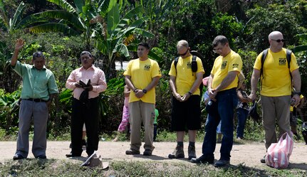 SOTO CANO AIR BASE, Honduras – Don Humberto Moreno, (second from left) a pastor from the mountain village of El Misterio, Honduras, prays before the start of a gift-giving ceremony April 18, 2015. During the ceremony, hikers from Joint Task Force-Bravo and the Honduran Air Force Academy presented 3,000 pounds of rice and other goods to the villagers of El Misterio, to show good will and build trust in Honduras. (U.S. Air Force photo by Staff Sgt. Jessica Condit)