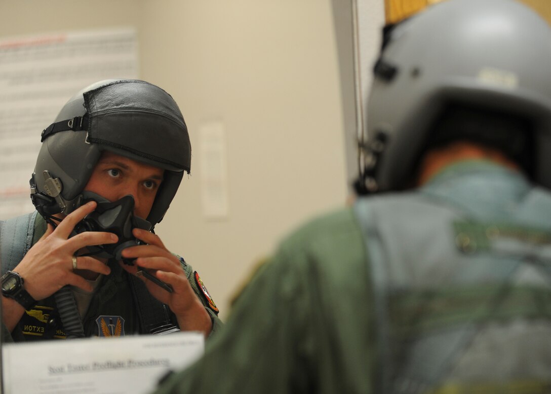 First Lt. Chris Sexton, 37th Bomb Squadron weapons system officer, performs an equipment check of his flight helmet at Ellsworth Air Force Base, S.D., April 29, 2015. Sexton is one of approximately 37 aircrew members from Ellsworth who participated in the Green Flag 15-07 exercise at the U.S. Army National Training Center at Fort Irwin, Calif. (U.S. Air Force photo by Senior Airman Anania Tekurio/Released)