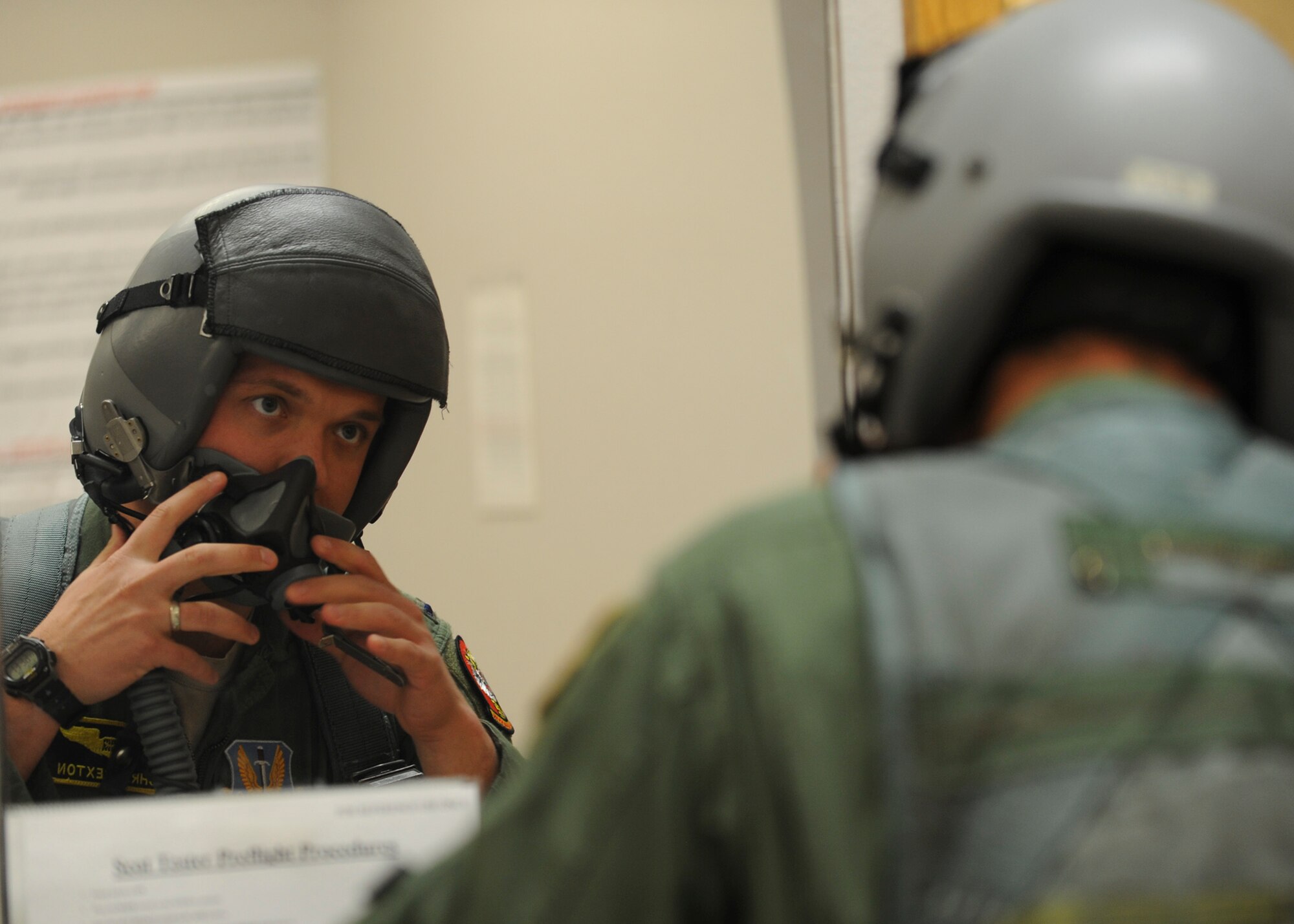 First Lt. Chris Sexton, 37th Bomb Squadron weapons system officer, performs an equipment check of his flight helmet at Ellsworth Air Force Base, S.D., April 29, 2015. Sexton is one of approximately 37 aircrew members from Ellsworth who participated in the Green Flag 15-07 exercise at the U.S. Army National Training Center at Fort Irwin, Calif. (U.S. Air Force photo by Senior Airman Anania Tekurio/Released)