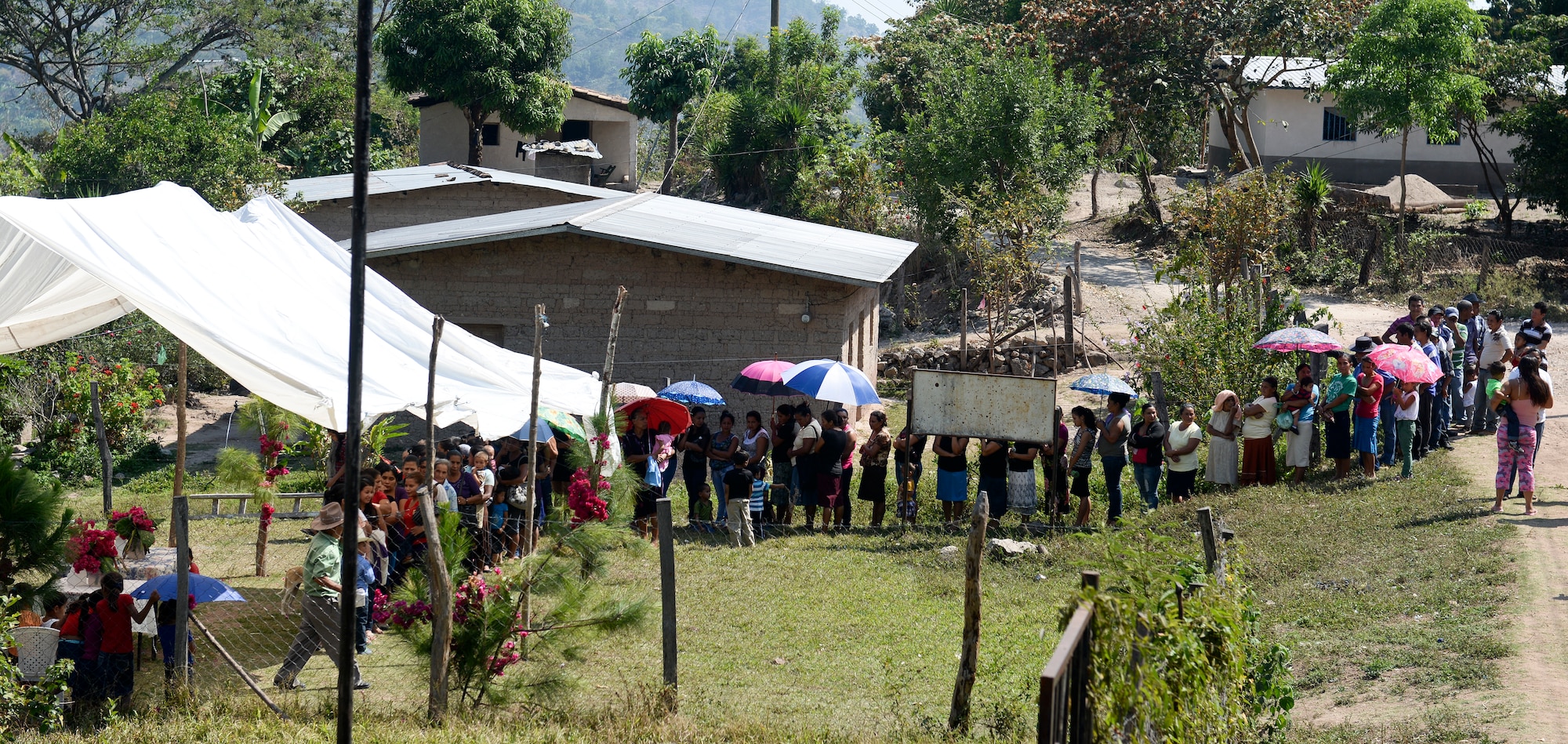 SOTO CANO AIR BASE, Honduras – Representatives from all the families in El Misterio, Honduras, line up in preparation for a gift-giving ceremony April 18, 2015. A total of 222 hikers from Joint Task Force-Bravo and the Honduran Air Force Academy carried 3,000 pounds of rice and other goods to the villagers, as part of the JTF-B chapel hike program. Since its inception, JTF-B has delivered more than 217,000 pounds of donated goods through these hikes. (U.S. Air Force photo by Staff Sgt. Jessica Condit)