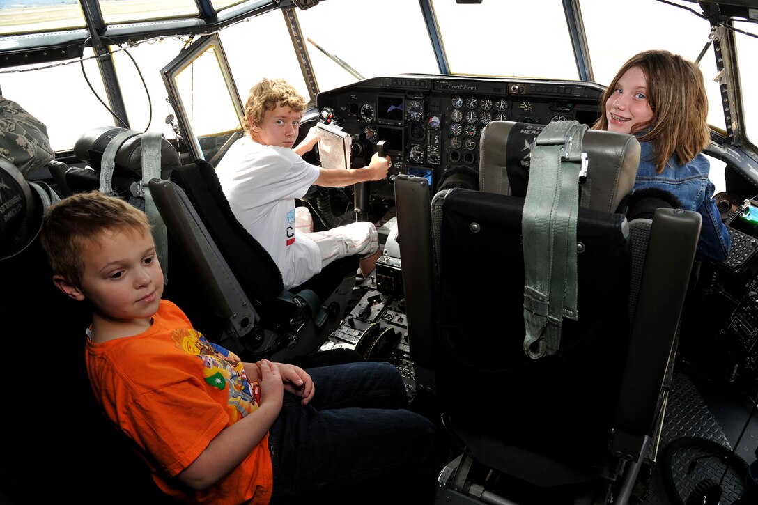 PETERSON AIR FORCE BASE, Colo. – (Left to right) Alex Wright, 8, Liam Glover, 14, and Sydney Morris, 10, explore the cockpit of a C-130H Hercules aircraft during a portion of the 21st Medical Group Bring Your Child to Work Day April 23. Participants experienced a number of hands-on activities throughout the day showing the many jobs available in the 21st MDG outside of being a doctor or nurse. (U.S. Air Force photo by Robb Lingley)