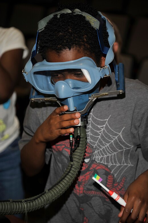 PETERSON AIR FORCE BASE, Colo. -- Caleb Gunn tries on an oxygen mask at the 302nd Airlift Wing during the 21st Medical Group Bring Your Child to Work Day April 23. Participants took part in several hands-on experiences during the day learning about the different jobs beside those of doctors and nurses that allow the 21st MDG to carry out its mission. (U.S. Air Force photo by Robb Lingley)
