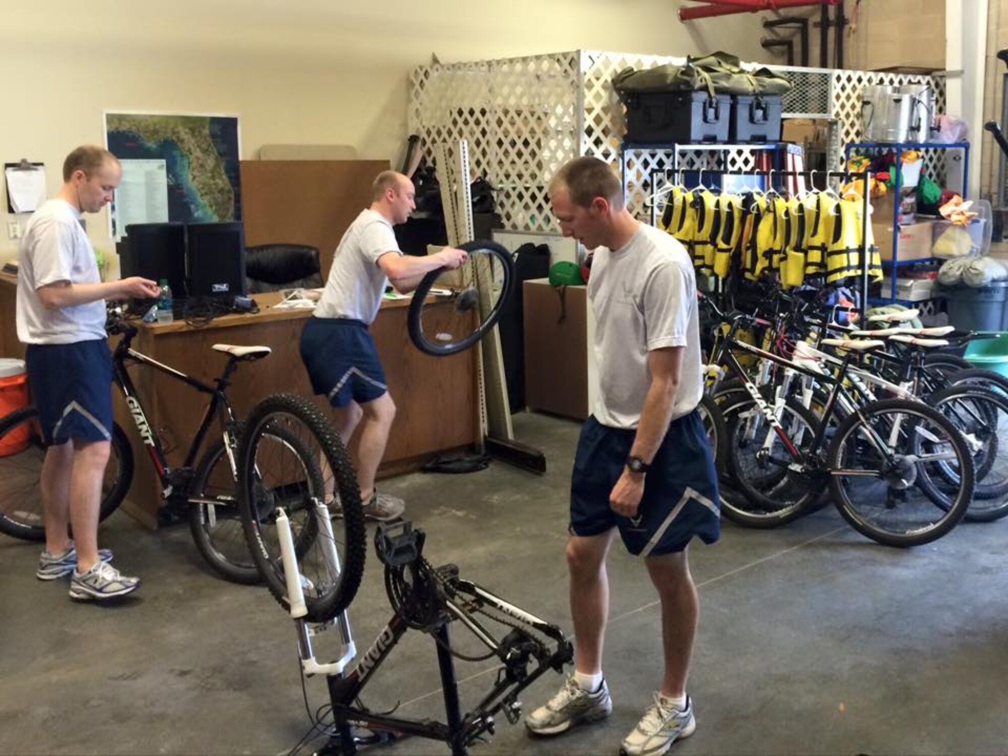 Senior Airman Michael Horne, Senior Airman Joseph Shumway, and Staff Sgt. Benjamin Dayley, of the 419th Services Flight, help repair a fleet of rental equipment to include bikes, boats and beach gear for the base’s Outdoor Recreation shop during their two-week annual tour training. 