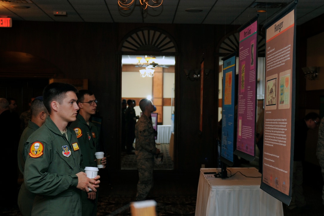 Airmen attended the silent viewing remembrance display at the Patriot Club. Patrons were on hand in celebration of the Days of Remembrance. The 55th Wing Diversity Awareness Team invited Capt. (Ret.) Roy Long, concentration camp liberator and World War II veteran, to offer his experiences of war at the Patriot Club on Offutt Air Force Base, Neb., April 20. (U.S. Air Force photo by Jeff W. Gates/Released)