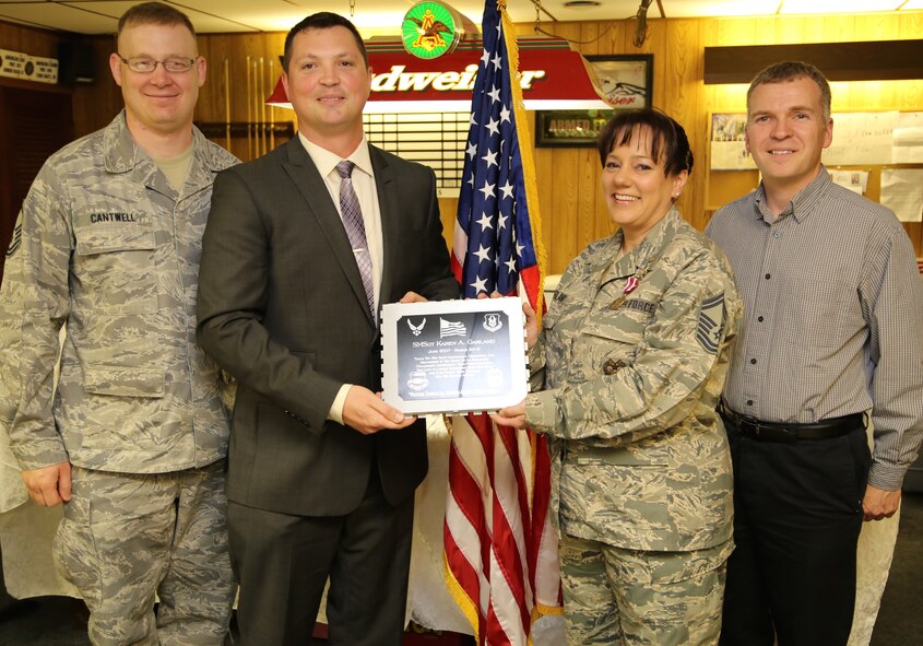 The final team farewell for a longtime 932nd Airlift Wing member was given in the form of a plaque of appreciation, as Senior Master Sgt. Karen Garland, approached the front of the room and said her last retirement goodbyes to well wishers recently.  She served with the 932nd Airlift Wing Combat Readiness Office, looking at the Air Force Instructions (AFI) as part of their ongoing preparation.  Garland had spent lthe ast several months reading the new AFI 90-201 that details the changing Air Force Inspection System and helps them to plan for future events. (U.S. Air Force photo/ Tech. Sgt. Christopher Parr)