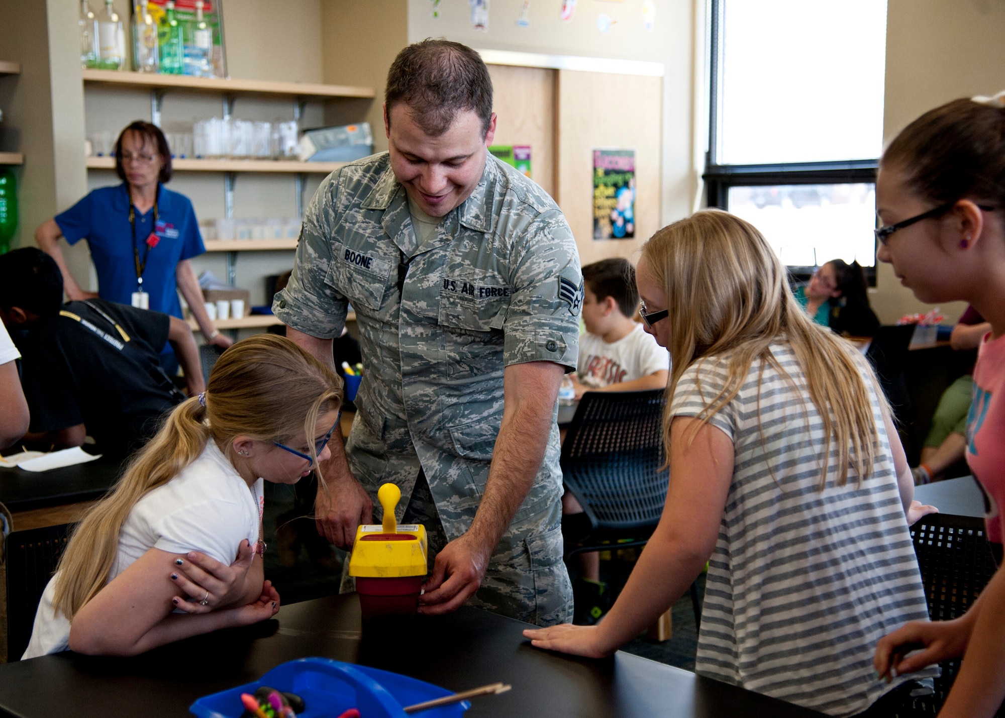 PETERSON AIR FORCE BASE, Colo. –Senior Airman James Boone, 21st Aerospace Medical Squadron bioenvironmental engineering technician, explains a piece of equipment to fifth grade students from Mark Twain Elementary at the STARBASE Academy, April 30, 2015. Staff Sgt. Jennifer Hobson and Boone described some of their daily duties and the science behind the chemical suits, and explained how they conduct water and chemical testing. STARBASE is a Department of Defense youth program where local students come to Peterson and learn about science, technology, engineering and math. (U.S. Air Force photo by Senior Airman Tiffany DeNault)