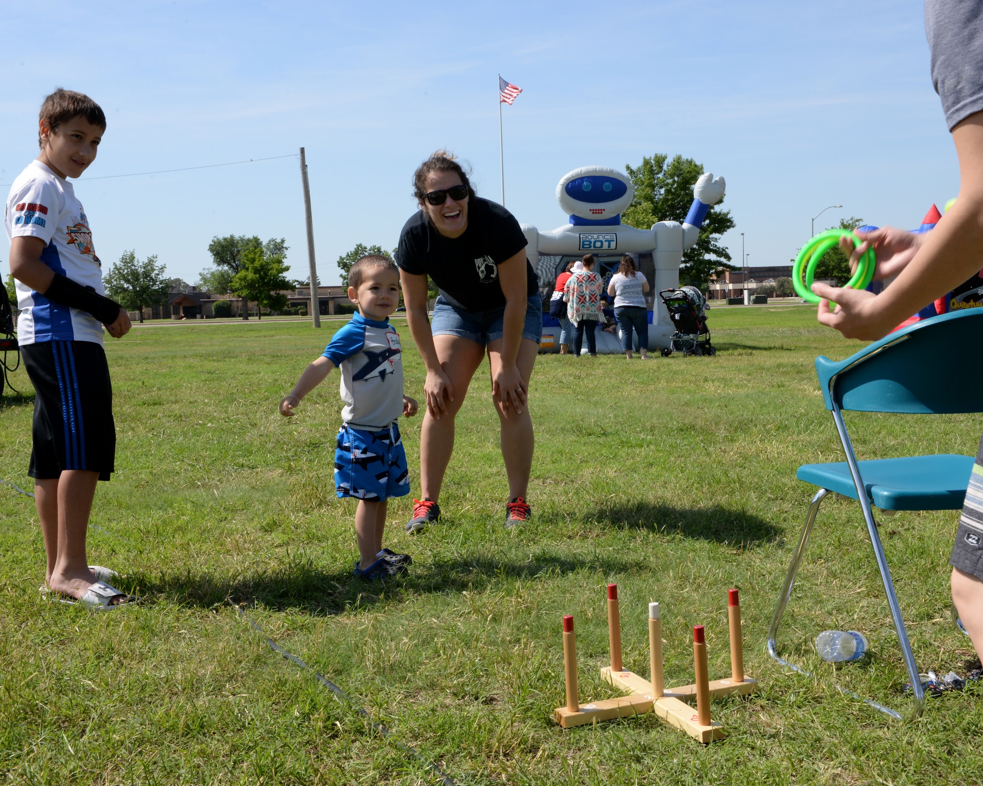 ALTUS AIR FORCE BASE, Okla. – Children play a game of ring toss at a deployed family event, May 2, 2015, near the mini-golf course. The event was carnival-themed and included games for the families including mini-golf, soda-bottle bowling, bean-bag toss, ring toss, fishing for candy and more. (U.S. Air Force photo by Airman 1st Class Megan E. Acs/Released)