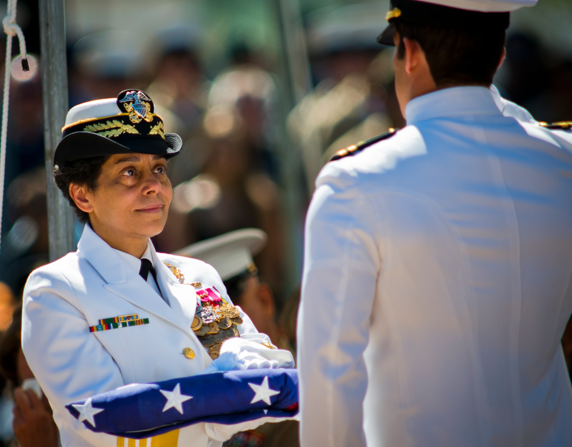 Vice Chief of Naval Operations Adm. Michelle Howard accepts a folded flag before presenting it to the family of a fallen explosive ordnance disposal technician at the EOD's 46th Annual Memorial Service at the Kauffman EOD Training Complex at Eglin Air Force Base, Fla., May 2. Eight names of Army, Marine and Navy service members were added to the EOD memorial wall. The all-service total now stands at 314. (U.S. Air Force photo/Tech. Sgt. Samuel King Jr.)