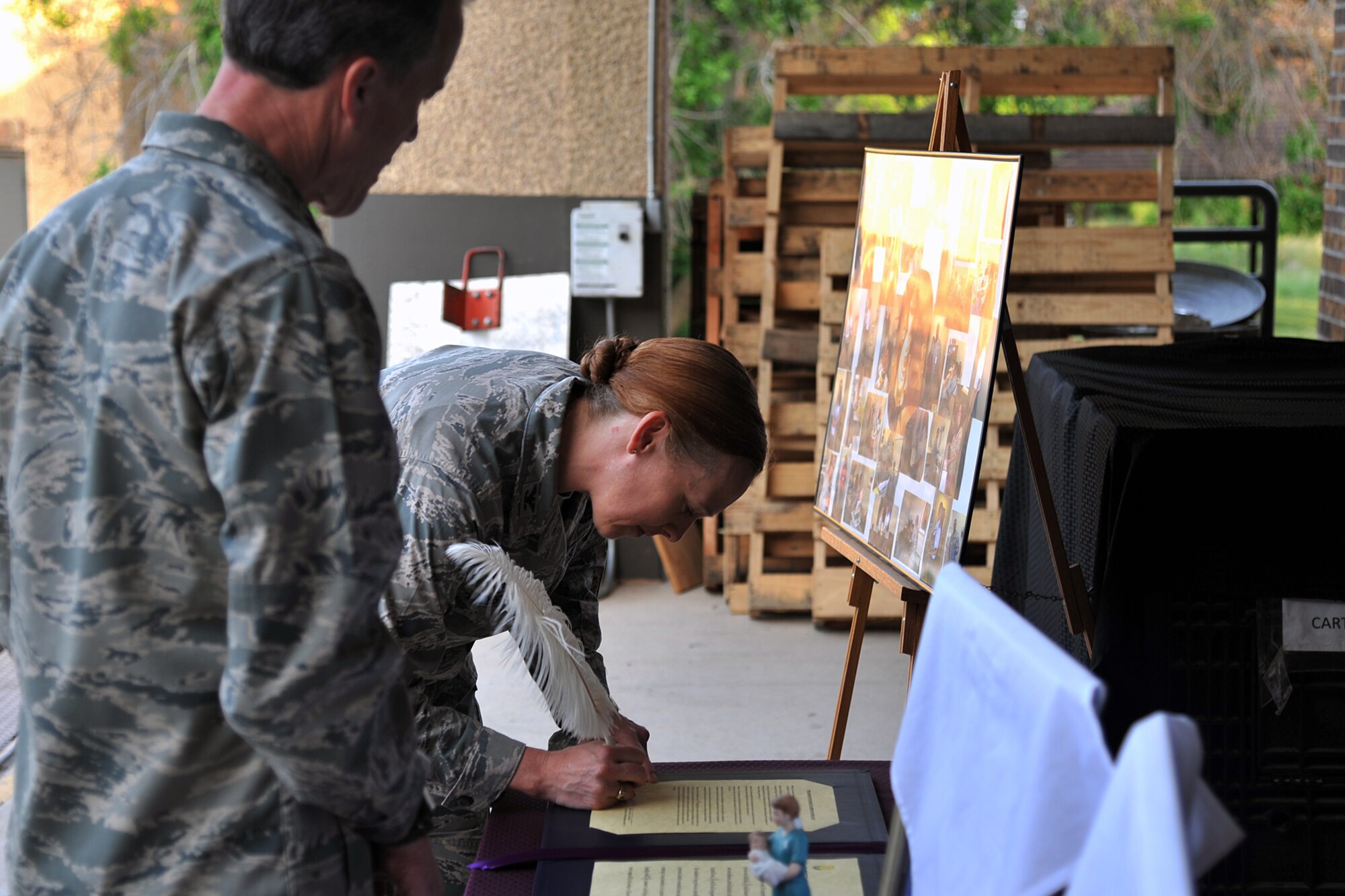 GOODFELLOW AIR FORCE BASE, Texas – Col. Kimberlee P. Joos, 17th Training Wing Commander, signs the Nurse and Medical Technician Week Proclamation with Lt. Col. Paul Miller Jr., 17th Medical Operations Squadron Commander, outside of the Ross Clinic May 4. Nurse and Medical Technician Week celebrates the work that nurses and medical technicians do and runs from May 6 to 12. (U.S. Air Force photo/ Airman 1st Class Devin Boyer)