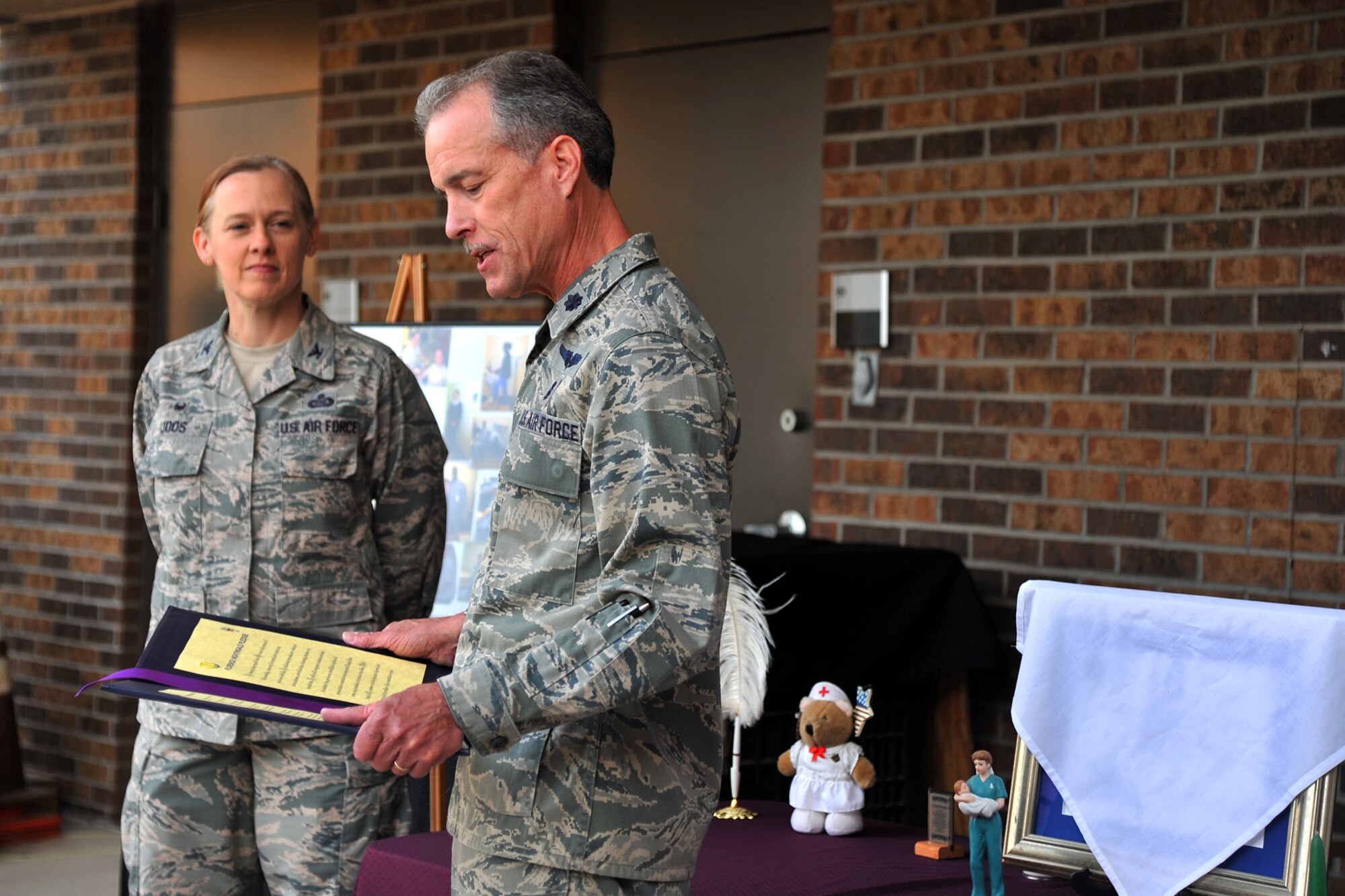 GOODFELLOW AIR FORCE BASE, Texas – Lt. Col. Paul Miller Jr., 17th Medical Operations Squadron Commander, reads off the Nurse and Medical Technician Week Proclamation with Col. Kimberlee P. Joos, 17th Training Wing Commander, outside of the Ross Clinic May 4. Nurse and Medical Technician Week celebrates the work that nurses and medical technicians do and runs from May 6 to 12. (U.S. Air Force photo/ Airman 1st Class Devin Boyer)