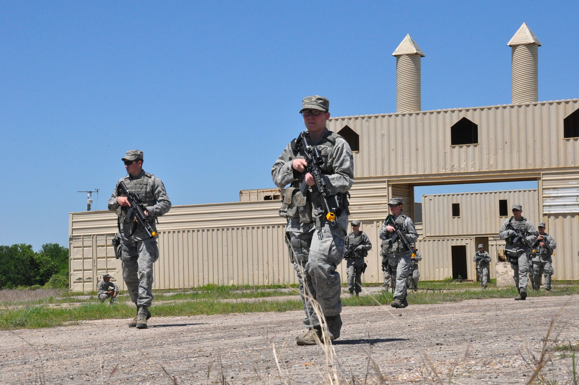 FORT WOLTERS TRAINING CENTER, Texas - Senior Airmen Shelby Money (foreground) and Alexander Stephens lead the way as a squad of 445th Security Forces Airmen participate in an urban operations practical April 14, 2015 at Fort Wolters Training Center, Texas. The practical was part of Patriot Defender, a two-week sustainment course that takes SFS troops through the paces of core security forces tasks. (U.S. Air Force photo/Capt. Elizabeth Caraway)