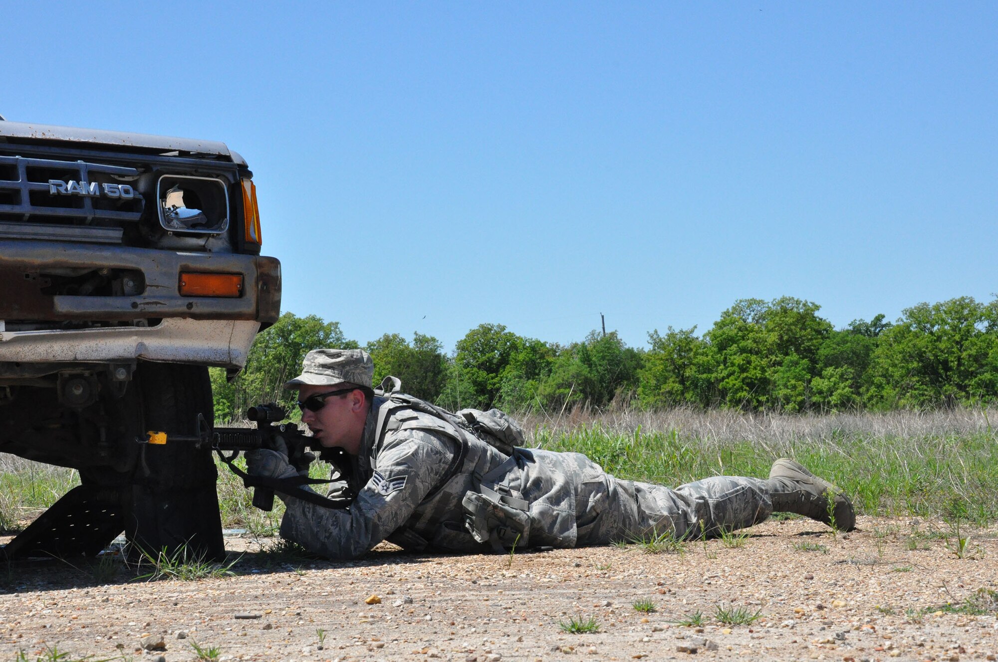 FORT WOLTERS TRAINING CENTER, Texas - Senior Airman Jalen McMahan, 445th Security Forces Squadron fire team member, takes position during an urban operations practical April 14, 2015 at Fort Wolters Training Center, Texas. The practical was part of Patriot Defender, a two-week sustainment course that takes SFS troops through the paces of core security forces tasks. (U.S. Air Force photo/Capt. Elizabeth Caraway)