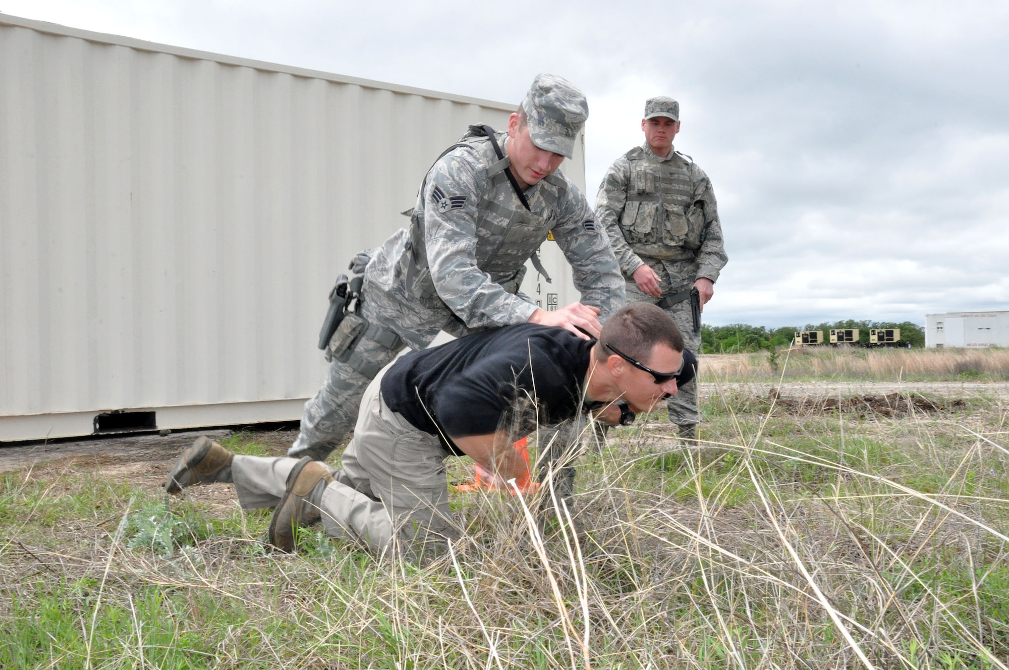 FORT WOLTERS TRAINING CENTER, Texas - Senior Airman Joshua Huber, 445th Security Forces Squadron fire team member, takes down instructor Tech. Sgt. Nathan Hagin, 610th Security Forces Squadron, during a simulated entry control point practical while Senior Amn Nicholas Livingston backs him up. Thirty-seven Airmen from the 445th SFS attended Patriot Defender training at Fort Wolters Training Center, Texas, April 6-17, 2015. Patriot Defender sustainment training takes SFS troops through the paces of core security forces tasks (U.S. Air Force photo/Capt. Elizabeth Caraway)