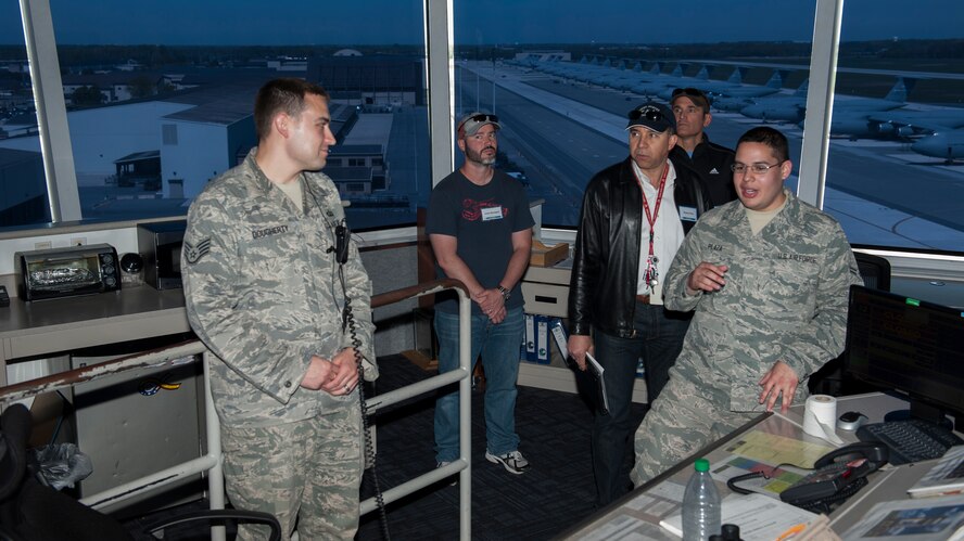 Staff Sgt. Ryan Dougherty, 436th Operations Support Squadron Air Traffic Control watch supervisor, left, and Airman 1st Class Marcos Plaza, 436th OSS air traffic controller apprentice, brief civilian pilots during the 2015 Dover Air Force Base Mid-Air Collision Avoidance Fly-in May 2, 2015, at Dover AFB, Del. The civilian pilots toured the Air Traffic Control complex. (U.S. Air Force photo/Airman 1st Class Zachary Cacicia)