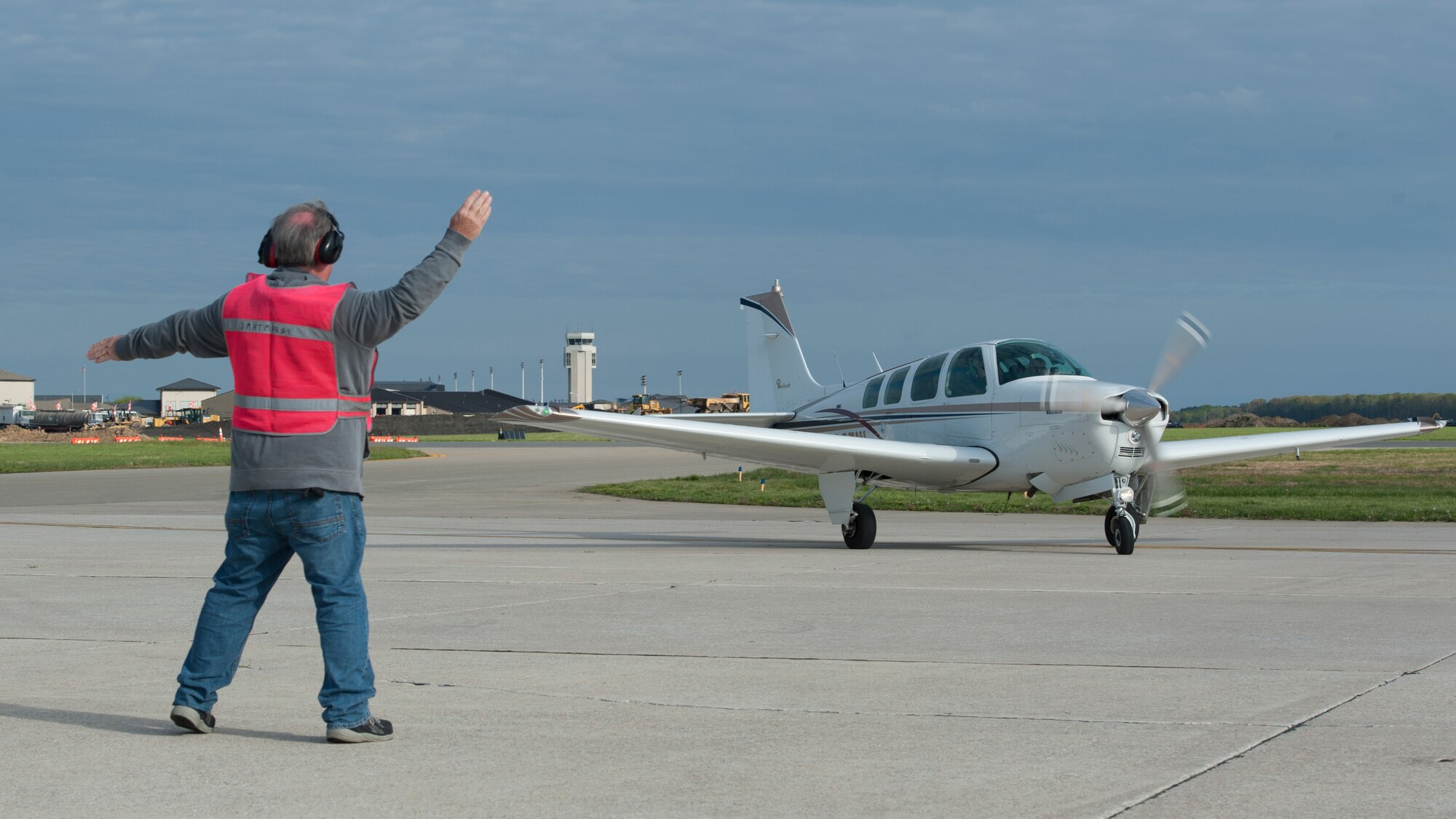 Bill Kennedy, 436th Aircraft Maintenance Squadron transit alert, marshals a privately owned aircraft during the 2015 Dover Air Force Base Mid-Air Collision Avoidance Fly-in May 2, 2015, at Dover AFB, Del. Pilots flew in from the from the Delmarva Peninsula and the surrounding states of Pa., Md., N.J. and Va. (U.S. Air Force photo/Airman 1st Class Zachary Cacicia)