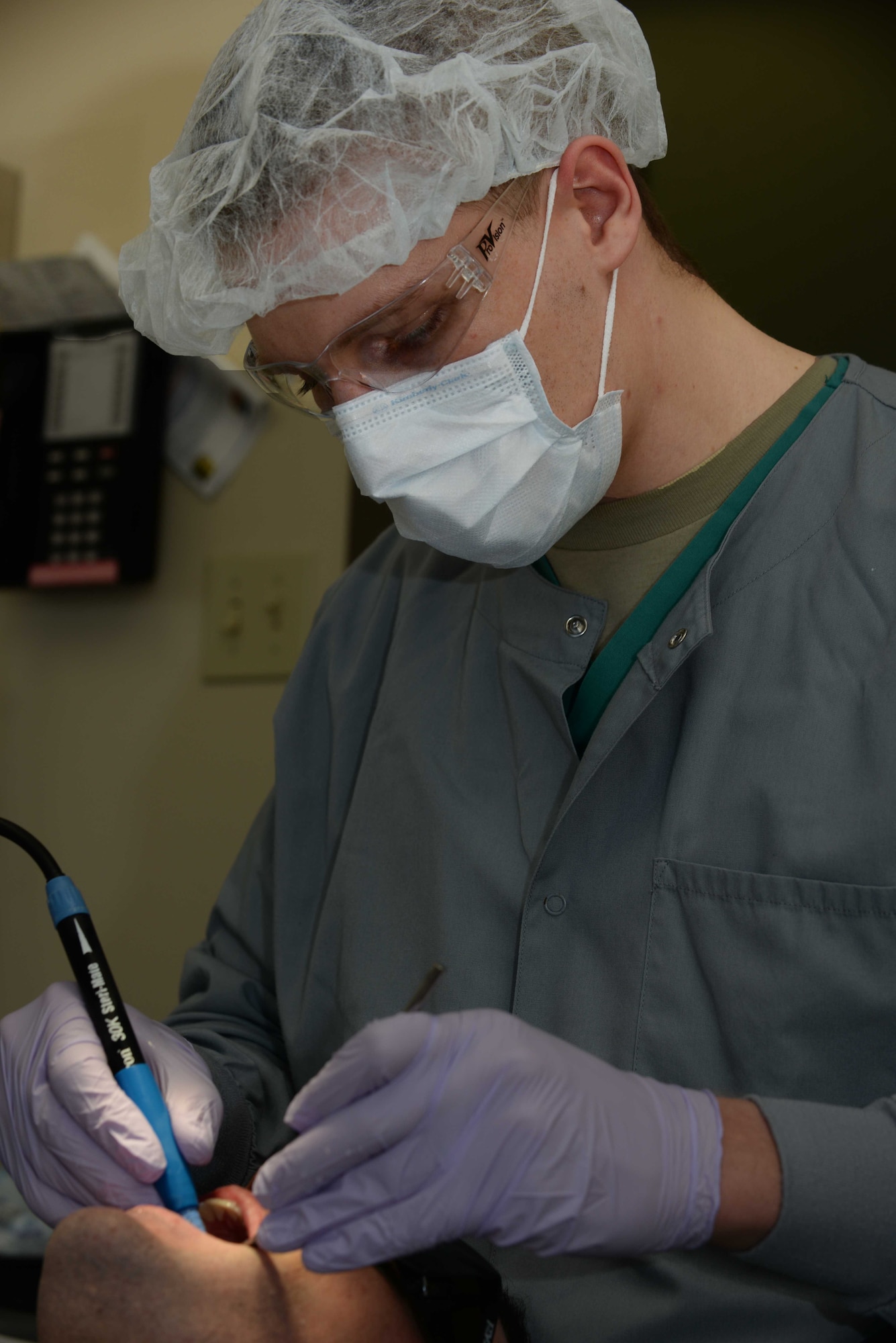 Senior Airman Jacob Van Scyoc, 28th Medical Operations Squadron dental assistant, performs a routine teeth cleaning on an Airman from the 432nd Attack Squadron, at Ellsworth Air Force Base, S.D., April 13, 2015. Ellsworth’s Dental Clinic was recently recognized as the Air Combat Command 2014 Small Dental Clinic of the Year for outstanding effectiveness in mission readiness, patient satisfaction and access to care. (U.S. Air Force photo by Airman 1st Class Rebecca Imwalle/Released)