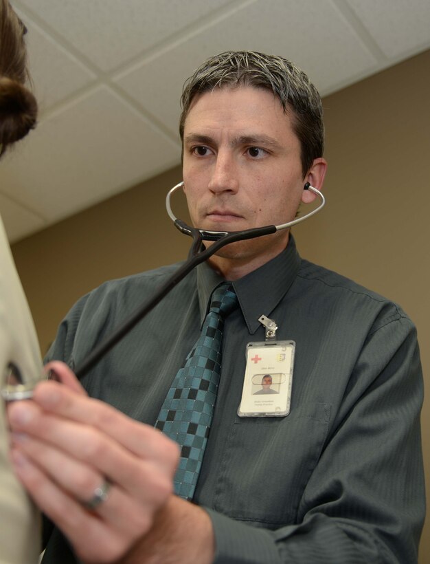 Blake Greenfield, 28th Medical Operation Squadron physician assistant, performs a check-up at Ellsworth Air Force Base, S.D., April 6, 2015. The collective efforts of members from the Ellsworth Family Health Clinic led to the winning of the 2014 Air Force Medical Service Outstanding Patient Center Medical Home award. (U.S. Air Force photo by Airman 1st Class Rebecca Imwalle/Released)