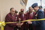 Documented Original Tuskegee Airmen from left Eugene Derricotte, Thomas M. Ellis, Granville C. Coggs, James L. Bynum and Gen. Robin Rand, commander of Air Education and Training Command, cut the ribbon May 4, 2015, at Joint Base San Antonio-Lackland’s U.S. Air Force Airman Heritage Museum & Enlisted Character Development Center.  The unveiling ceremony honors the enlisted Tuskegee Airmen, a group of African-American military ground support Airmen who were part of the 332nd Fighter Group and the 477th Bombardment Group during World War II.  The exhibit, a three-dimensional recreation of a World War II combat operations room displaying an enlisted aircraft line mechanic, enlisted administrator and a Tuskegee fighter pilot, depicts the hard work, sacrifice and determination the Tuskegee Airmen put forth as members of the Army Air Corps to help America win World War II. (U.S. Air Force photo by Johnny Saldivar/released)