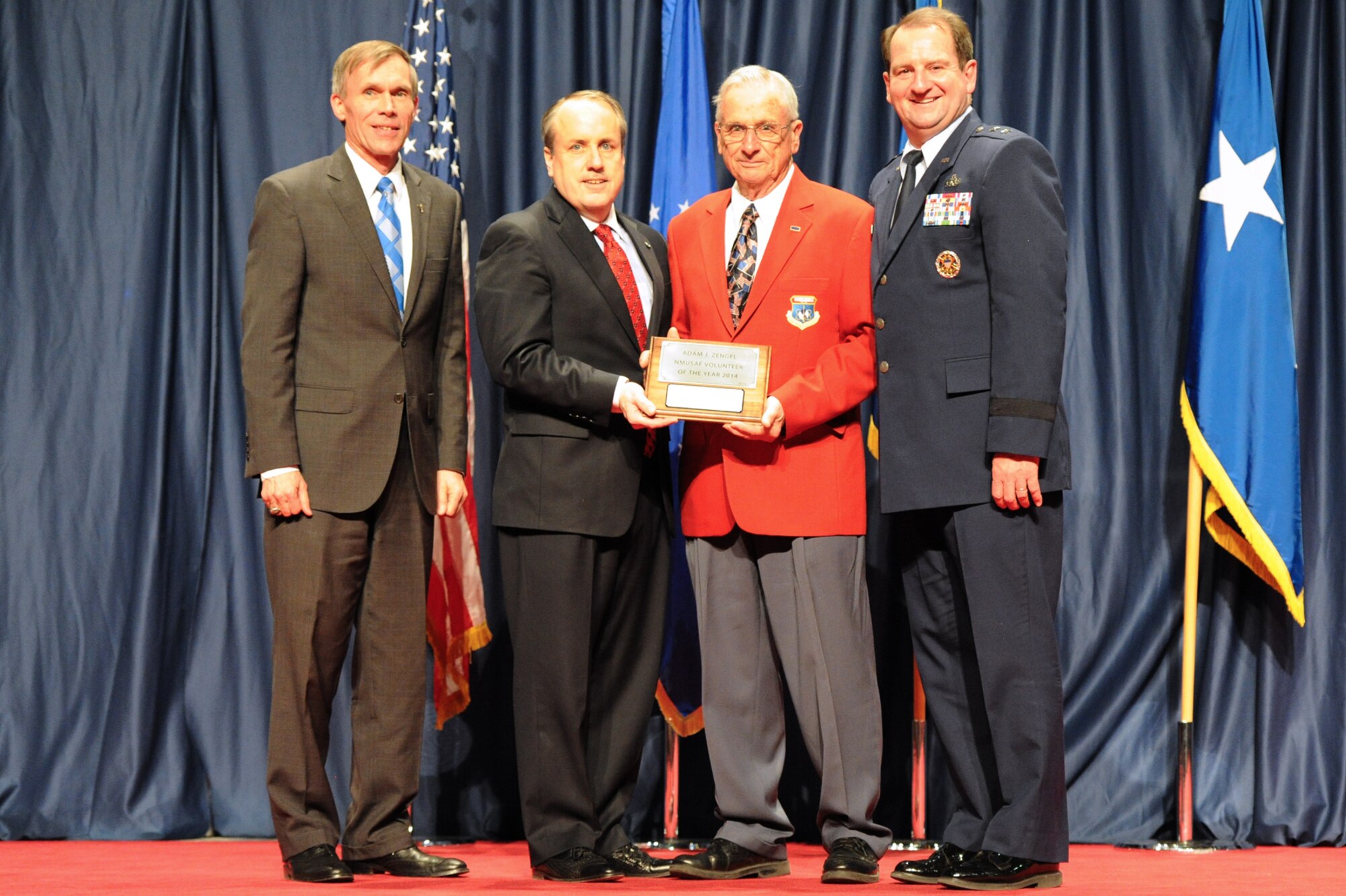 DAYTON, Ohio -- Adam Zengel (red jacket) received the 2014 Director’s Award for Volunteer of the Year for his dedication and excellence in serving the National Museum of the U.S. Air Force. (from left to right) Museum Director Lt. Gen. (Ret.) Jack Hudson, Air Force Museum Foundation Executive Director Mike Imhoff, Museum Volunteer Adam Zengel, and Maj. Gen. (Ret.) Charles Cooper. (U.S. Air Force photo)
