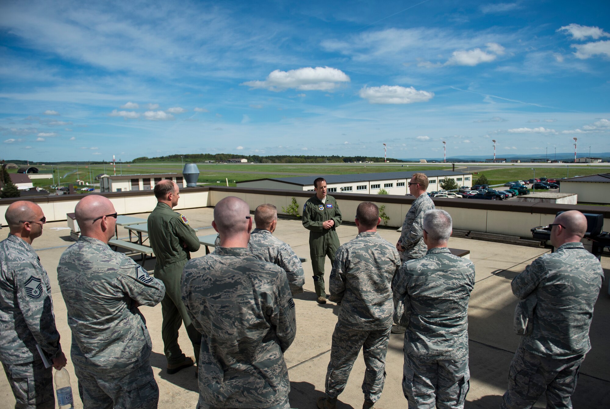 U.S. Air Force Lt. Col. Ryan Nudi, 52nd Fighter Wing chief of safety, center, addresses wing leadership before the group participated in a demonstration of the base’s wildlife management programs at Spangdahlem Air Base, Germany, May 4, 2015. The programs include trapping, hunting, falconry and clearing of nests. (U.S. Air Force photo by Airman 1st Class Luke Kitterman/Released)