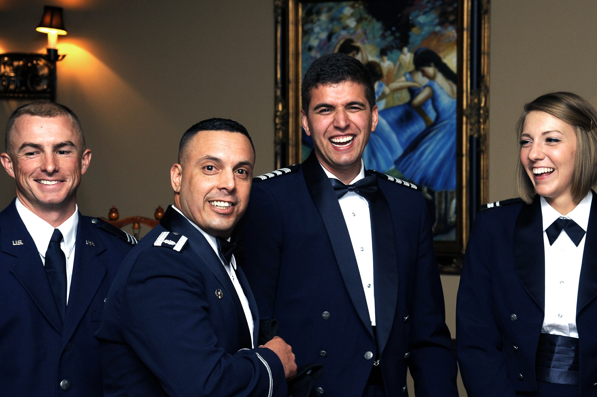 U.S. Air Force Lt. Col. Pedro E. Matos, Air Force ROTC Detachment 847 Commander, laughs with senior cadets at the 45th Annual 847th Cadet Wing Dining Out Awards Banquet at the LeGrande Alumni Center in San Angelo, Texas May 1, 2015. The dining out has served the Air Force well as an opportunity for the commander to meet with subordinates in an atmosphere of good fellowship.  (U.S. Air Force photo/Tech. Sgt. Austin Knox)