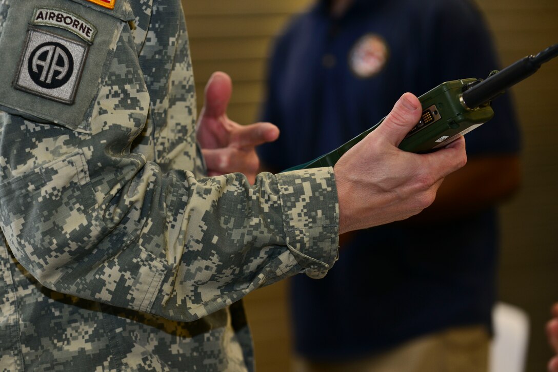 U.S. Army Maj. Jason Engelbrecht, Joint Task Force-Civil Support future operations planner, picks up a radio in a gear collection line during exercise Vibrant Response 15 at Fort Eustis, Va., April 30, 2015. VR 15 is a domestic disaster response exercise that tests federal civilian and military response to domestic crises. (U.S. Air Force photo by Senior Airman Kimberly Nagle/Released)  