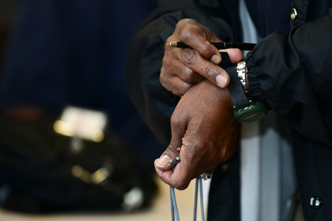 Cathy Thomas, Joint Task Force-Civil Support Joint Movement Center chief, places a radiation watch on her wrist during exercise Vibrant Response 15 at Fort Eustis, Va., April 30, 2015. The watch would detect possible chemical, biological, radiological and nuclear items. The exercise is set to provide training to prepare for possible CBRN attacks. (U.S. Air Force photo by Senior Airman Kimberly Nagle/Released)  
