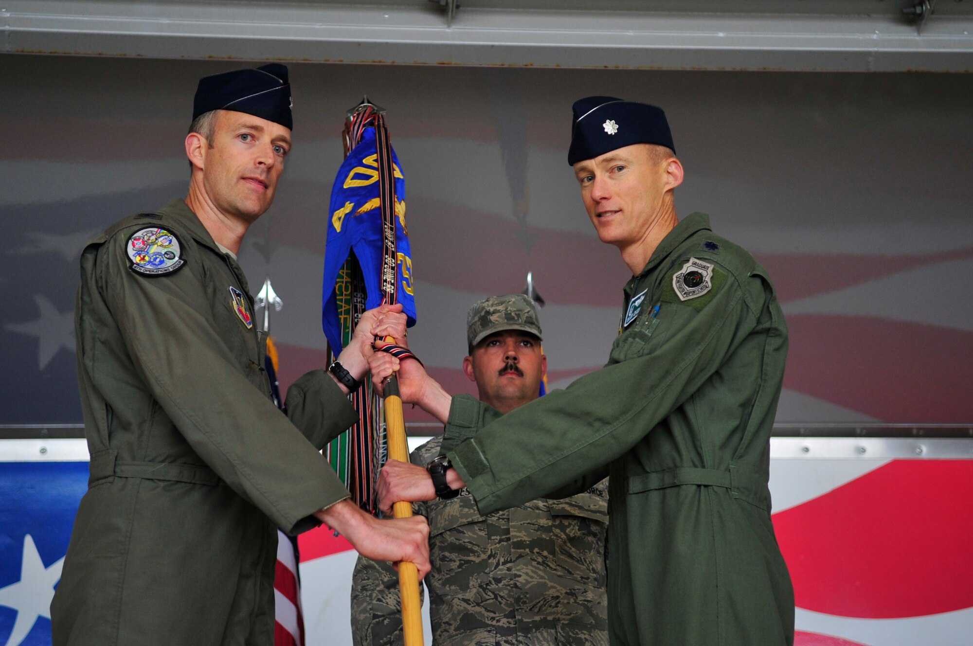 Lt. Col. Brandon Johnson, incoming 335th Fighter Squadron commander, accepts the guidon from Col. Brian Afflerbaugh, 4th Operations Group commander, at the squadron’s change of command ceremony, May 1, 2015, at Seymour Johnson Air Force Base, North Carolina. Johnson accepted command of the squadron formerly led by Lt. Col. Todd Dyer. (U.S. Air Force photo/Airman Shawna L. Keyes)