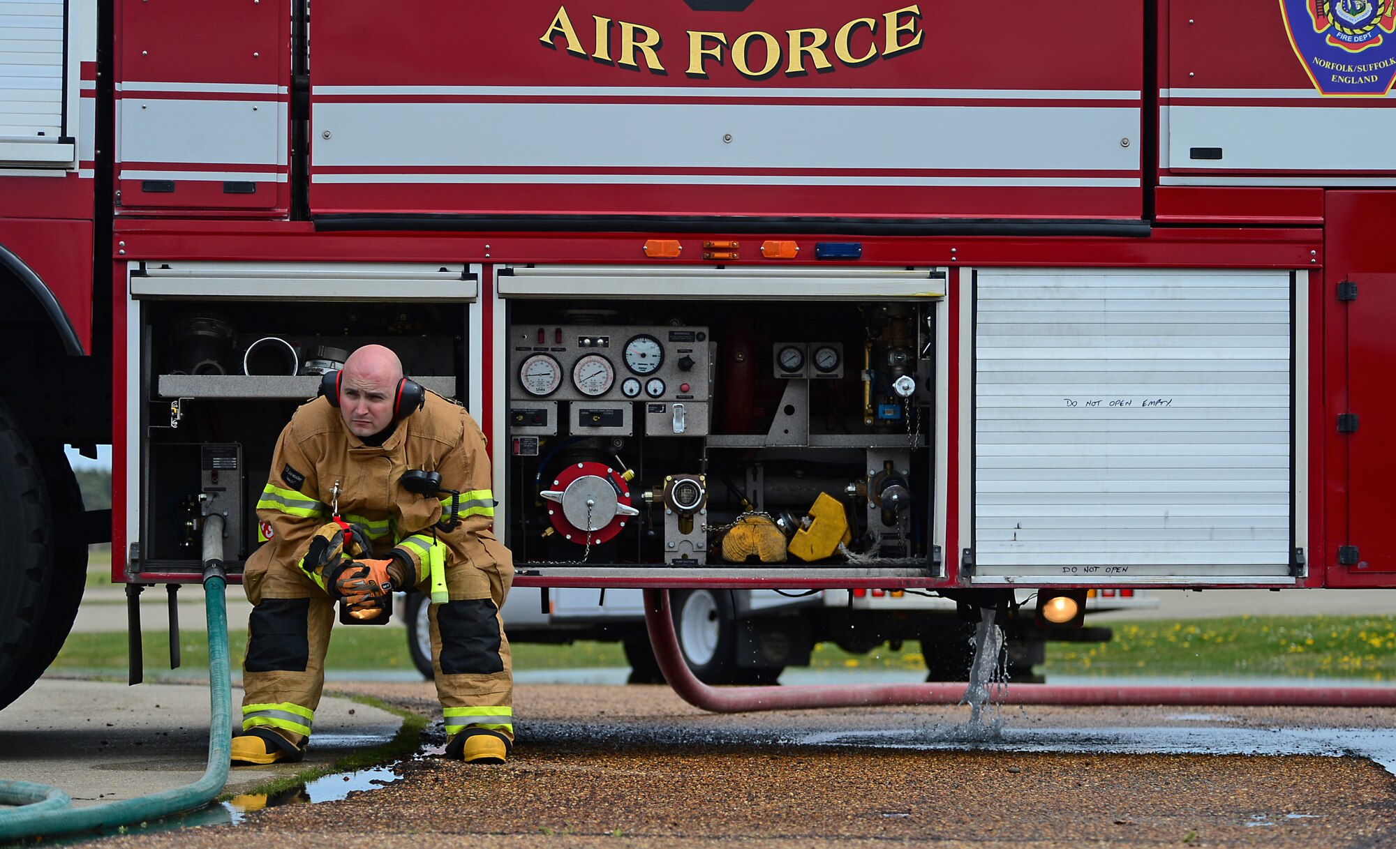 Tech. Sgt. Kevin Coughlin, 48th Civil Engineer Squadron firefighter and station captain, observes a training exercise on the flightline during a spouses’ day at Royal Air Force Lakenheath, England, May 1, 2015. The event allowed the firefighters’ family members to experience what work days entail and provided a better understanding of daily responsibilities at the station. (U.S. Air Force photo by Senior Airman Erin O’Shea/Released)