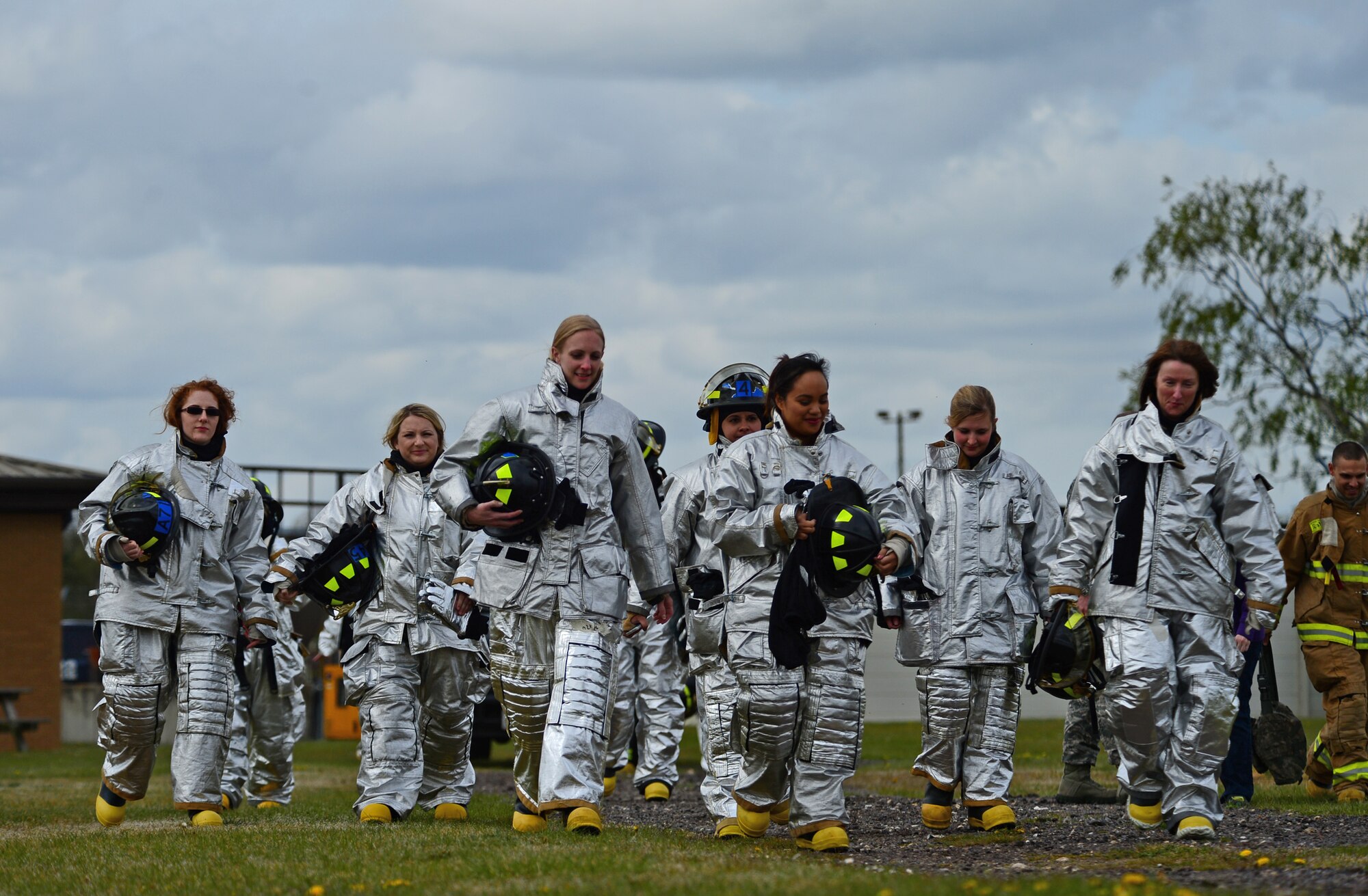 Spouses of 48th Civil Engineer Squadron firefighters prepare for a training exercise on the flightline at Royal Air Force Lakenheath, England, during a spouses’ day, May 1, 2015. The event allowed the families of firefighters to spend the day learning about roles and duty responsibilities at the station. (U.S. Air Force photo by Senior Airman Erin O’Shea/Released)