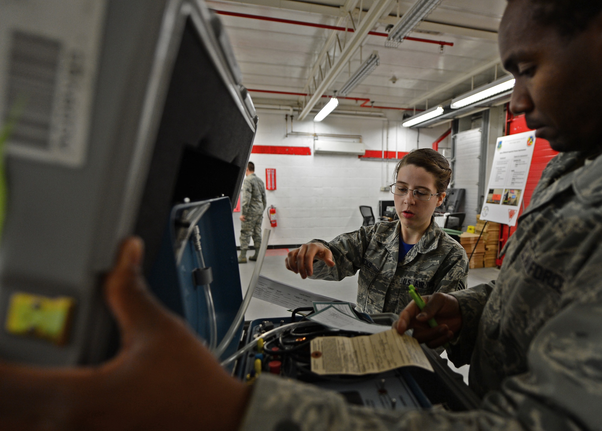 Staff Sgt. Tiffany Hicks, 48th Logistics Readiness Squadron equipment accountability element supervisor, inspects a kit with Staff Sgt. Ferrel Derigious, 48th Component Maintencance Squadron egress systems craftsman, at Royal Air Force Lakenheath, England, May 1, 2015. Hicks was nominated for a Liberty Spotlight because she embodies the core value of Service Before Self. (U.S. Air Force photo by Airman 1st Class Erin R. Babis/Released)