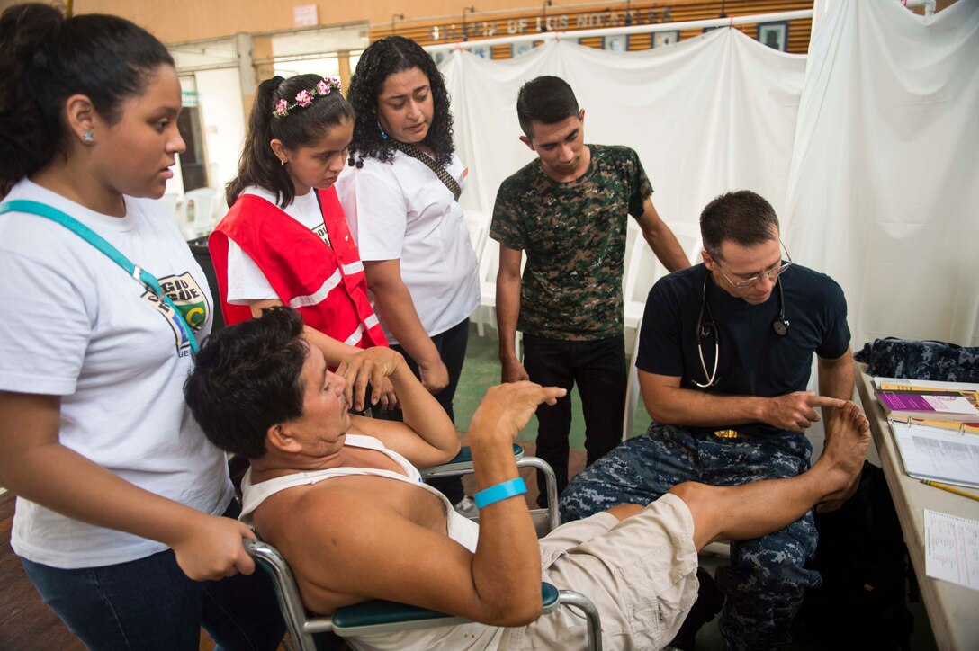 Navy Cmdr. John Devlin examines a patient at a medical site set up at Complejo Deportivo de Puerto Barrios during Continuing Promise 2015 in Puerto Barrios, Guatemala, April 30, 2015. Continuing Promise is a U.S. Southern Command-sponsored and U.S. Naval Forces Southern Command/U.S. 4th Fleet-conducted deployment that included humanitarian-civil assistance, subject-matter expert exchanges, medical, dental, veterinary and engineering support and disaster response to partner nations. Devlin is a physician assigned to Naval Medical Center Portsmouth, Va.