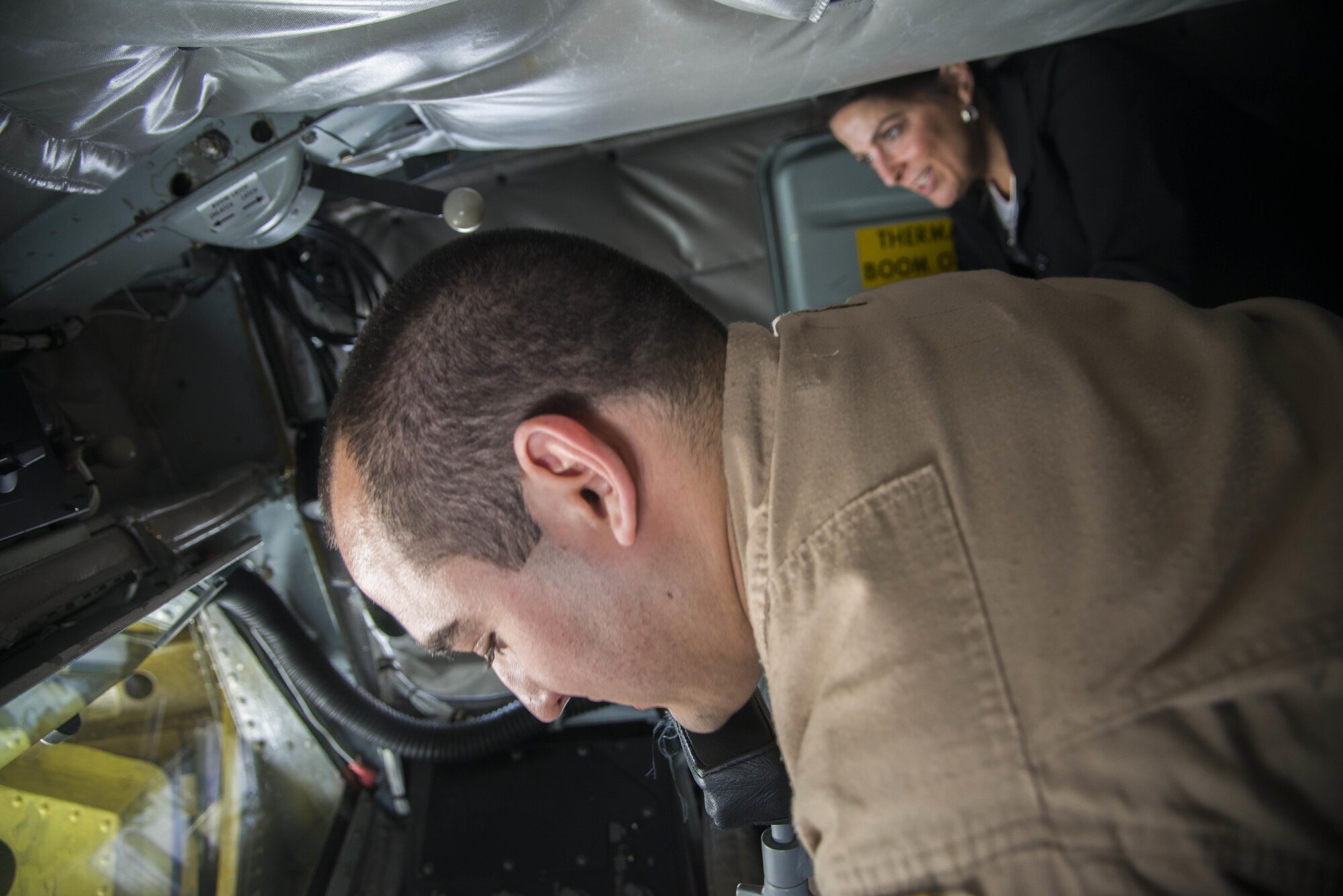 U. S. Air Force Senior Airman Hector Acevedo, 340th Expeditionary Air Refueling Squadron boom operator, shows U.S. Ambassador to Qatar, Dana Shell Smith, how they control the boom of a KC-135 Stratotanker April 27, 2015 at Al Udeid Air Base. (U.S. Air Force photo by Tech. Sgt.Rasheen Douglas) 