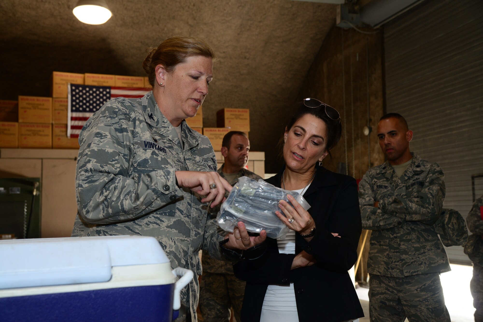 U.S. Ambassador to Qatar, Dana Shell Smith listens to Col. Andrea Vinyard, 379th Expeditionary Medical Group commander, explain to her what an individual first aid kit consists of April 27, 2015 at the Blood Transshipment Center at Al Udeid Air Base, Qatar. The BTC was on stops during her visit to the AUAB.  (U.S. Air Force photo/Tech. Sgt. Rasheen Douglas)