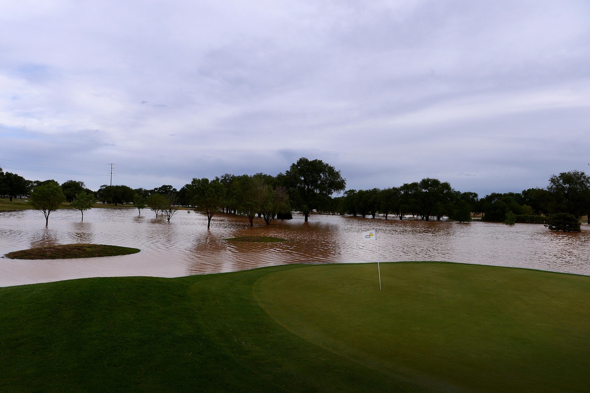 Heavy rain fall flooded Whispering Winds golf course after a severe weather storm May 5, 2015 at Cannon Air Force Base, N.M. The 18-hole course is currently completely submerged in stagnant water, taking out 600 feet of fencing as a repercussion. (U.S. Air Force photo/Staff Sgt. Matthew Plew) 
