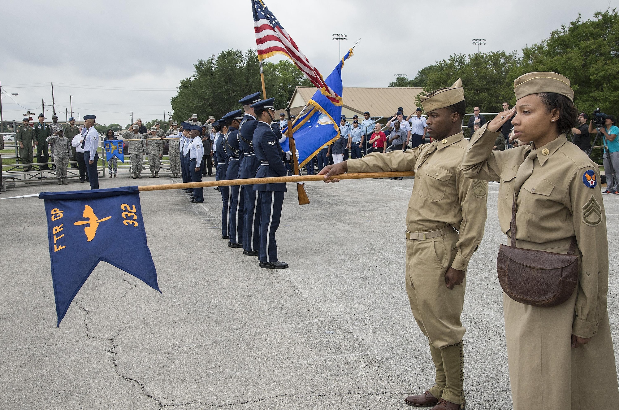 Chief Master Sgt. Richard West, U.S. Air Force Airman Heritage Museum & Enlisted Character Development Center director, leads a flight of Joint Base San Antonio Airmen on a performance tribute while wearing historic military uniforms during an unveiling ceremony for the Enlisted Tuskegee Airman Exhibit May 4, 2015, at Joint Base San Antonio-Lackland’s U.S. Air Force Airman Heritage Museum & Enlisted Character Development Center. The unveiling ceremony honors the Tuskegee Airmen, a group of African-American military ground support Airmen who were part of the 332nd Fighter Group and the 477th Bombardment Group during World War II. The exhibit, a three-dimensional recreation of a World War II combat operations room displaying an enlisted aircraft line mechanic, enlisted administrator and a Tuskegee fighter pilot, depicts the hard work, sacrifice and determination the Tuskegee Airmen put forth as members of the Army Air Corps to help America win World War II. (U.S. Air Force photo by Johnny Saldivar)