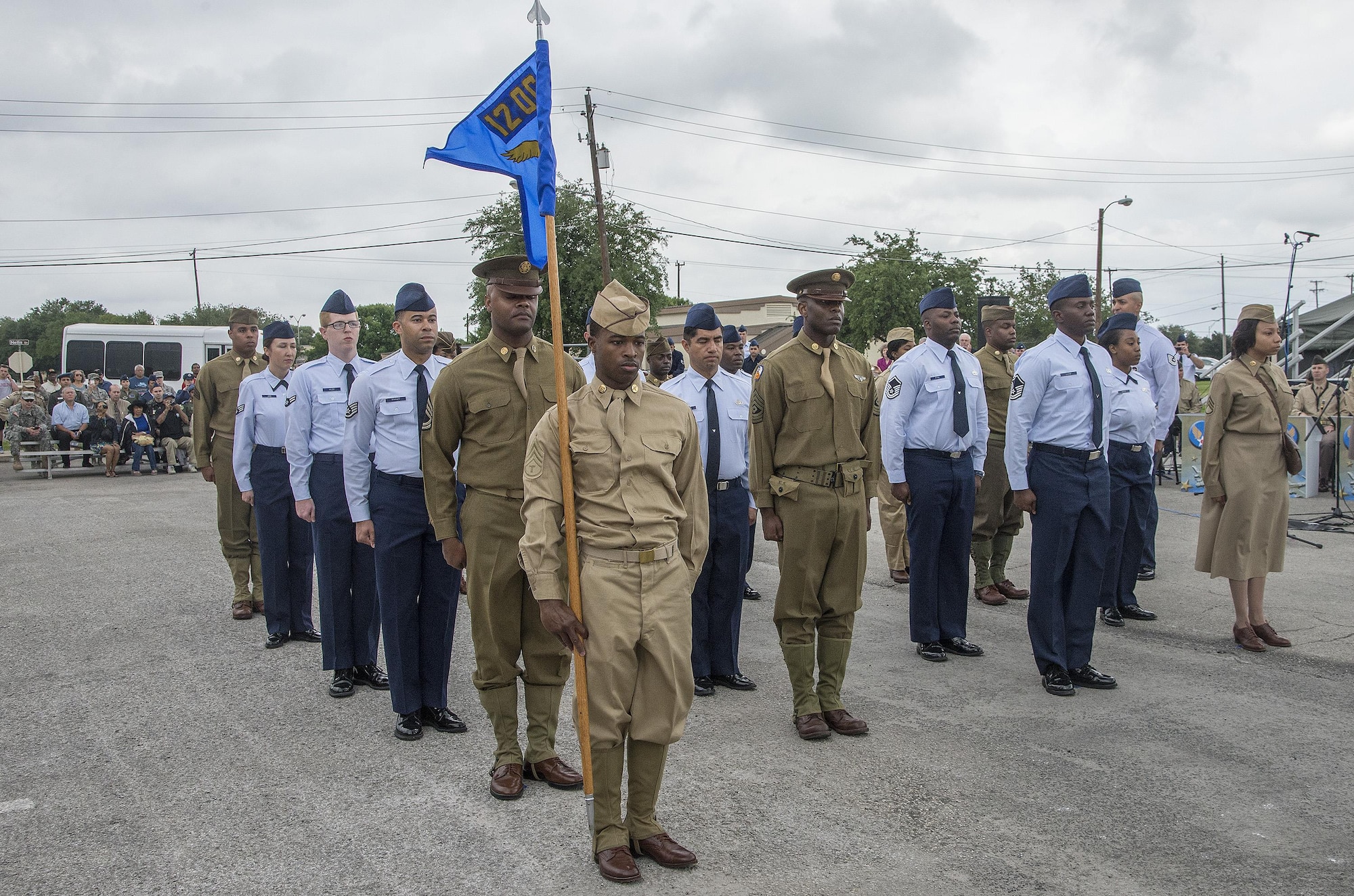 Chief Master Sgt. Richard West, U.S. Air Force Airman Heritage Museum & Enlisted Character Development Center director, leads a flight of Joint Base San Antonio Airmen on a performance tribute while wearing historic military uniforms during an unveiling ceremony for the Enlisted Tuskegee Airman Exhibit May 4, 2015, at Joint Base San Antonio-Lackland’s U.S. Air Force Airman Heritage Museum & Enlisted Character Development Center. The unveiling ceremony honors the Tuskegee Airmen, a group of African-American military ground support Airmen who were part of the 332nd Fighter Group and the 477th Bombardment Group during World War II. The exhibit, a three-dimensional recreation of a World War II combat operations room displaying an enlisted aircraft line mechanic, enlisted administrator and a Tuskegee fighter pilot, depicts the hard work, sacrifice and determination the Tuskegee Airmen put forth as members of the Army Air Corps to help America win World War II. (U.S. Air Force photo by Johnny Saldivar)