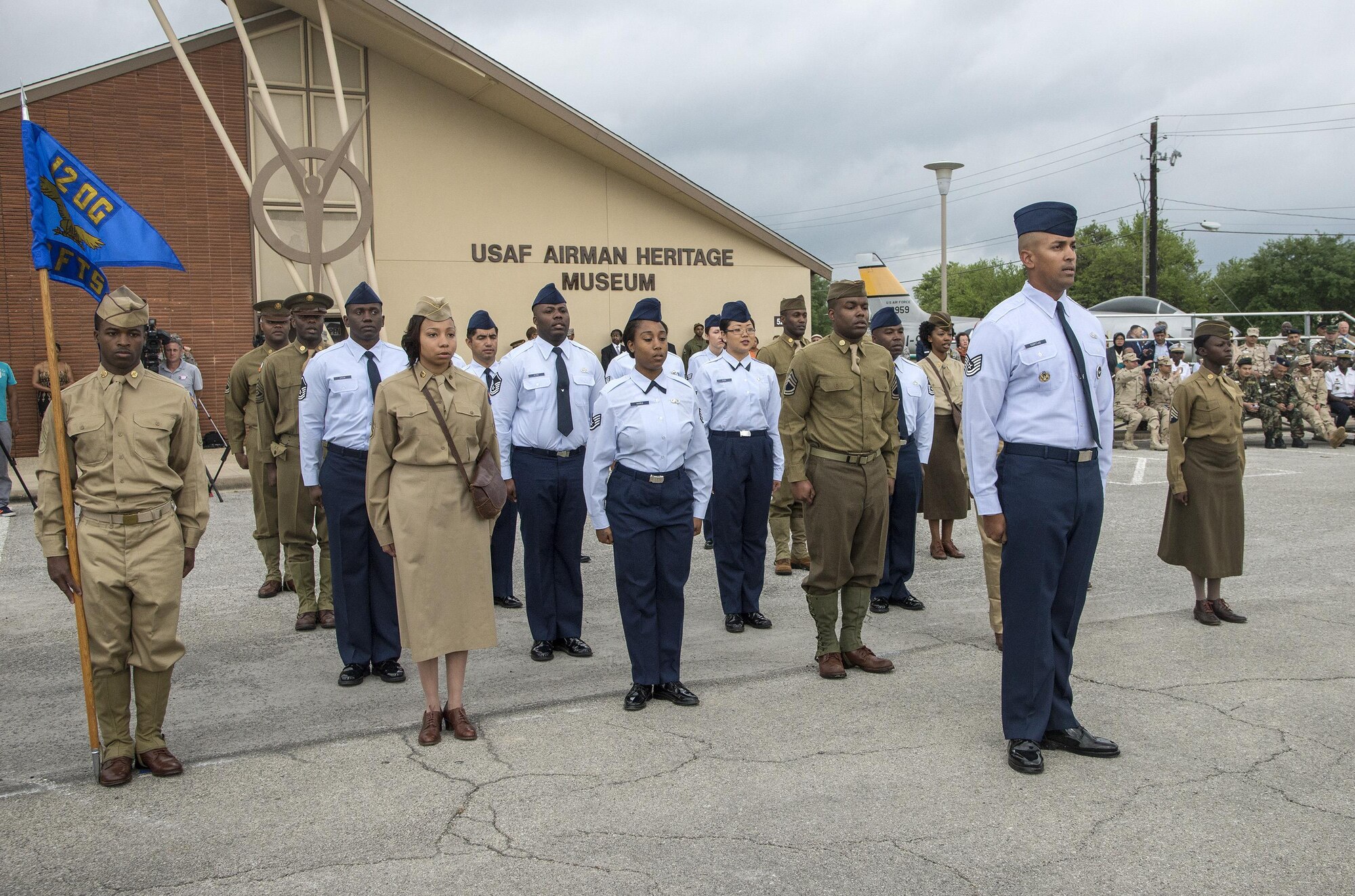 Joint Base San Antonio Airmen perform a drill sequence during an unveiling ceremony for the Enlisted Tuskegee Airman Exhibit May 4, 2015, at Joint Base San Antonio-Lackland’s United States Air Force Airman Heritage Museum & Enlisted Character Development Center. The unveiling ceremony honors the enlisted Tuskegee Airmen, a group of African-American military ground support Airmen who were part of the 332nd Fighter Group and the 477th Bombardment Group during World War II. The exhibit, a three-dimensional recreation of a World War II combat operations room displaying an enlisted aircraft line mechanic, enlisted administrator and a Tuskegee fighter pilot, depicts the hard work, sacrifice and determination the Tuskegee Airmen put forth as members of the Army Air Corps to help America win World War II. (U.S. Air Force photo by Johnny Saldivar)