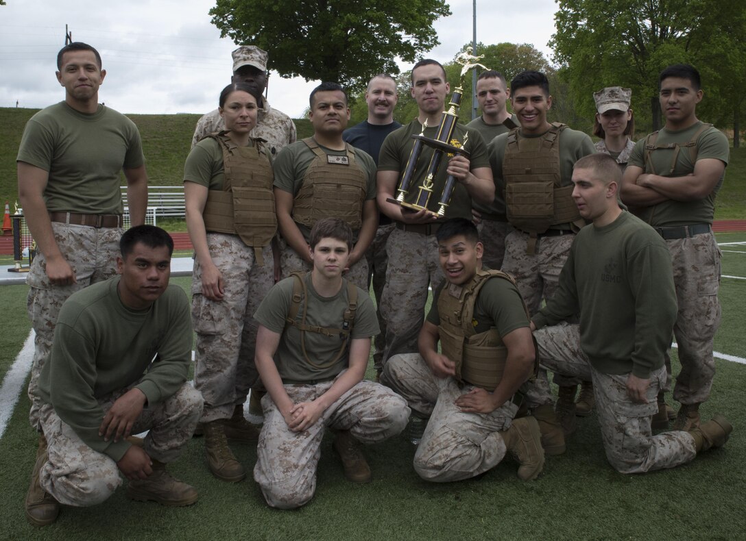 Marines from Marine Corps Recruiting Command pose with their trophy after competing in a Marine Corps Martial Arts Program (MCMAP)gauntlet at Butler Stadium, May 1, 2015. The Marines participated in pugil stick and grappling bouts. The team took third place. 