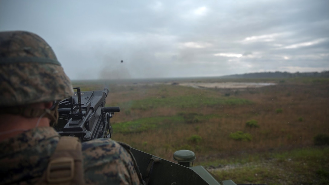 A Marine from 2nd Marine Division fires a MK-19 grenade launcher during the Advanced Machine Gunners Course at range G-3 aboard Camp Lejeune, N.C., April 30, 2015. In order to learn a new engagement method previously only employed by mortarmen, the Marines shot the MK-19 grenade launcher from behind a berm at targets that were not visible to them so that they could fire at the enemy without being in harm’s way. (U.S. Marine Corps Photo by Lance Cpl. Aaron Fiala/Released)