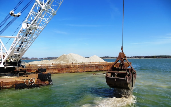 The U.S. Army Corps of Engineers, Baltimore District, places shell to restore oyster reefs in the Chesapeake Bay tributary of Harris Creek, April 1, 2015. The shell comes from processing plants in the mid-Atlantic region and is permitted to be imported and placed in the river. There is not sufficient natural shell available to restore oyster habitat in the Bay. Therefore, artificial reefs, known as substrate or alternative substrate, have been constructed at restoration locations throughout the Bay. Substrate may be any combination of oyster shell, clam shell, or alternative substrate such as crushed concrete, rock or granite.The shell is 2 to 3 inches in diameter. (U.S. Army Photo by Sean Fritzges)