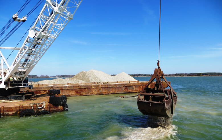 The U.S. Army Corps of Engineers, Baltimore District, places shell to restore oyster reefs in the Chesapeake Bay tributary of Harris Creek, April 1, 2015. The shell comes from processing plants in the mid-Atlantic region and is permitted to be imported and placed in the river. There is not sufficient natural shell available to restore oyster habitat in the Bay. Therefore, artificial reefs, known as substrate or alternative substrate, have been constructed at restoration locations throughout the Bay. Substrate may be any combination of oyster shell, clam shell, or alternative substrate such as crushed concrete, rock or granite.The shell is 2 to 3 inches in diameter. (U.S. Army Photo by Sean Fritzges)