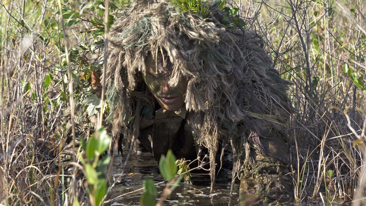Corporal Barton Harmon, a scout with Scout Sniper Platoon, Weapons Company, 2nd Battalion, 2nd Marine Regiment, crawls through a flooded field to get into a firing position during a stalking exercise in the vicinity of SR-10 aboard Marine Corps Base Camp Lejeune, North Carolina, April 22, 2015. The stalking exercise was one of many conducted by Marines attending the Scout Sniper Basic Preparation Course over the course of two weeks.