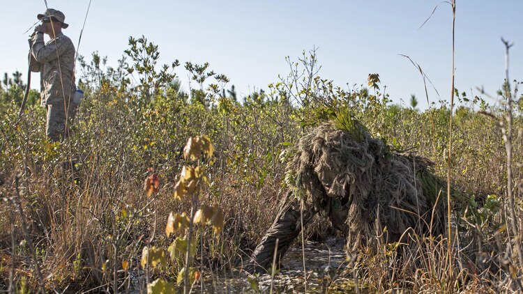 Corporal Barton Harmon, a scout with Scout Sniper Platoon, Weapons Company, 2nd Battalion, 2nd Marine Regiment crawls through a flooded field during a stalking exercise in the vicinity of SR-10 aboard Marine Corps Base Camp Lejeune, North Carolina, April 22, 2015. The stalking exercise was one of many conducted by Marines attending the Scout Sniper Basic Preparation Course over the course of two weeks during the month of April.