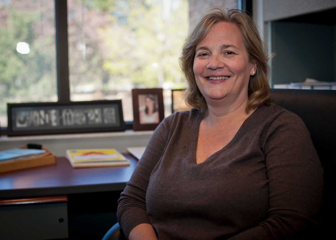 Jane-Marie Kopycinski, a 21st Force Support Squadron Airman and Family Readiness Center consultant, poses for a photo in her office April 17, 2015, on Peterson Air Force Base, Colo. In addition to being a member of the A&FRC team, Kopycinski is also an Air Force Aid officer, a role in which she helps provide monetary assistance to Airmen and their families. (U.S. Air Force photo/Staff Sgt. Aaron Breeden)