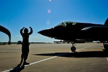 Airman 1st Class Allison Lasher, 33rd Aircraft Maintenance Squadron crew chief, marshals Lt. Col. Christine Mau, 33rd Operations Group deputy commander, as she prepares to take off for her first flight on Eglin Air Force Base, Florida, May 5, 2015. Mau, who previously flew F-15E Strike Eagles, made history as the first female F-35 pilot in the program. (U.S. Air Force photo/Staff Sgt. Marleah Robertson)