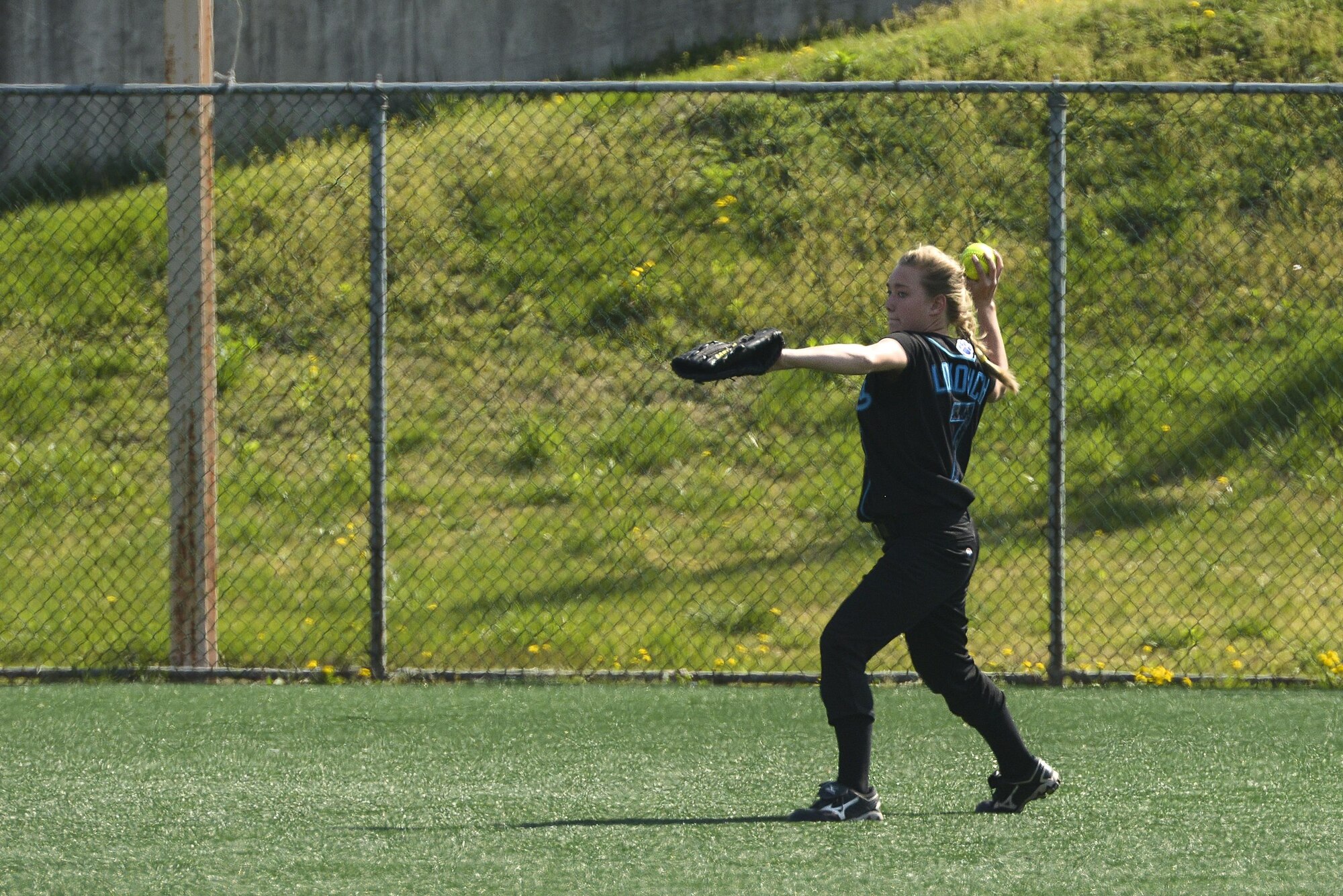 Avery Lokowich, daughter of Lt. Col. Luke Lokowich, the 5th Reconnaissance Squadron commander and a U-2 pilot, preapres to throw a softball during her softball game April 25, 2015, at Osan Air Base, South Korea. Avery is a freshman who plays for the Osan American High School Cougars softball team. (U.S. Air Force photo/Staff Sgt. Jake Barreiro)