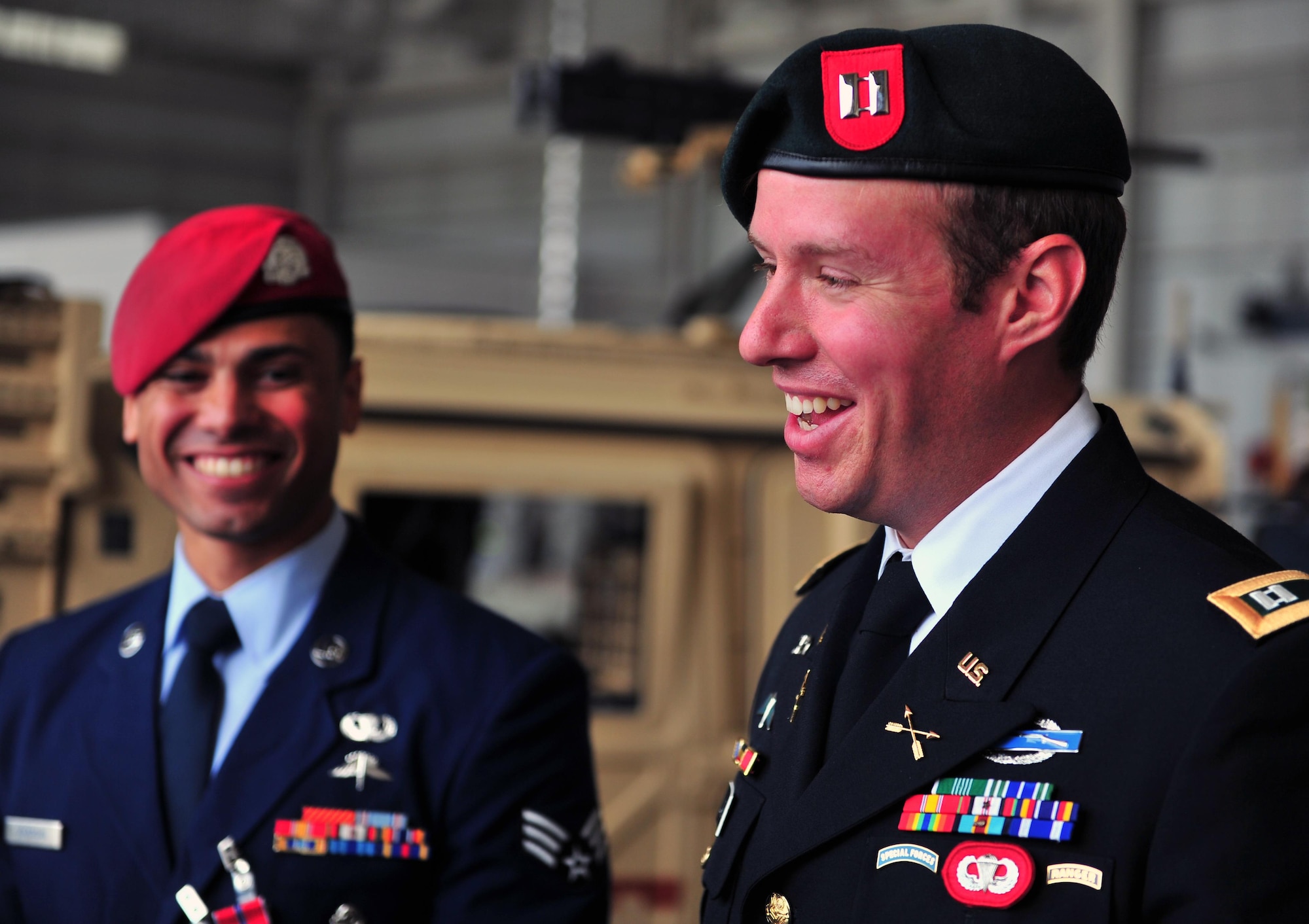 U.S. Army Capt. Evan Lacenski, Special Forces team leader for the three combat controllers, laughs with Senior Airman Goodie Goodman, Special Tactics combat controller and Silver Star recipient. Capt. Lacenski credits the combat controllers' control of close air support with saving lives of their joint teammates in a 48-hour battle. Three U.S. Air Force Special Tactics combat controllers received multiple decorations of high valor today for a single event, only the second battle in U.S. Air Force history resulting in an Air Force Cross and multiple Silver Stars since 9/11. Senior Airman Dustin Temple received the Air Force Cross, a medal second only to the Medal of Honor, and Tech. Sgt. Matthew Greiner and Senior Airman Goodie Goodman received the Silver Star. All provided crucial air-to-ground integration during a 48-hour firefight with nearly 100 insurgents. (U.S. Air Force photo by Airman First Class Ryan Conroy/Released)