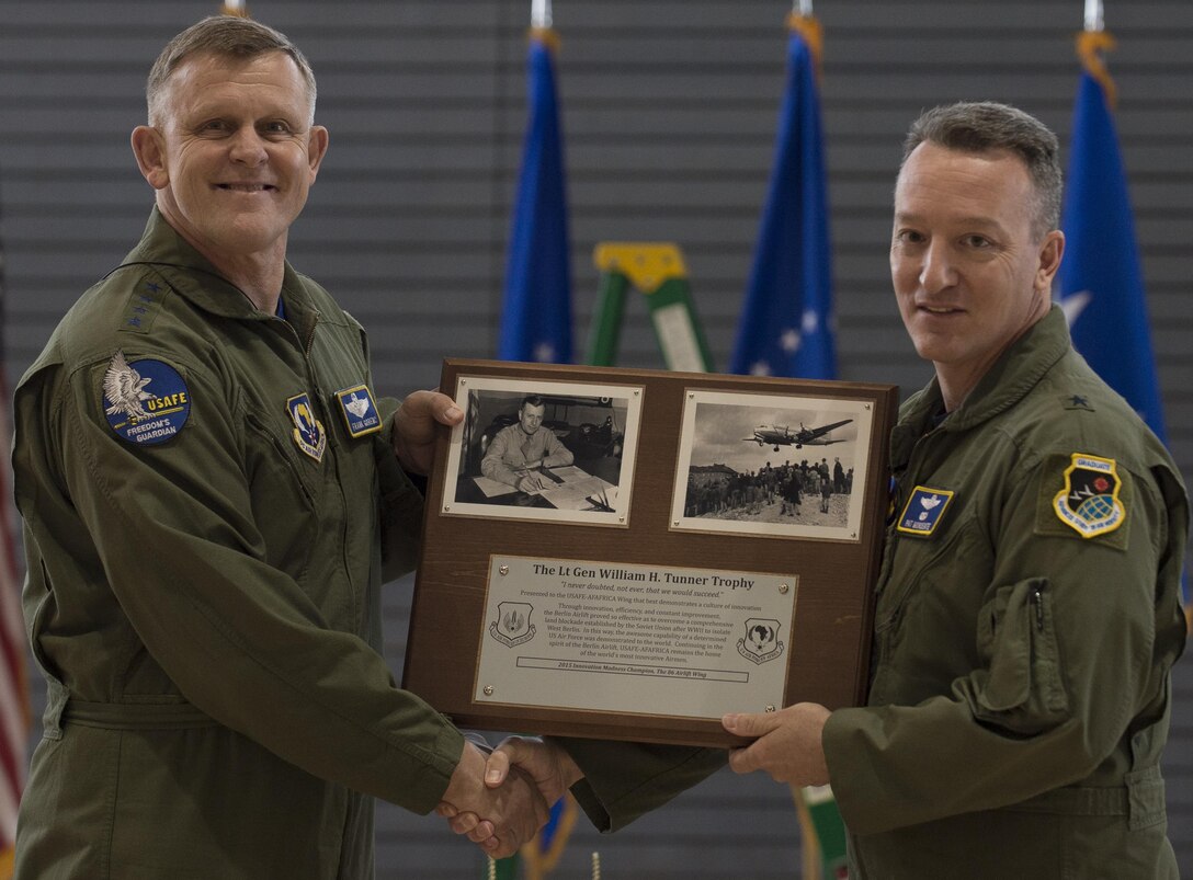 Gen. Frank Gorenc, the U.S. Air Forces in Europe and Air Forces Africa commander, presents Brig. Gen. Patrick X. Mordente, the 86th Airlift Wing commander, with the Lt. Gen. William H. Tunner Trophy for demonstrating a culture of innovation and winning the first Innovation Madness tournament May 1, 2015, at Ramstein Air Base, Germany. The inaugural competition started with nine wings from around USAFE-AFAFRICA competing with each other in a tournament-style match to determine which wing promotes the best innovative culture. (U.S. Air Force photo/Senior Airman Jonathan Stefanko)